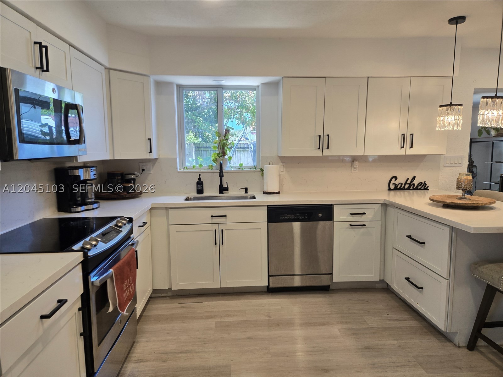 Substantially remodeled and move-in ready, this single-story concrete-block home sits in Hollywood's established Boulevard Heights. The open-concept layout showcases a renovated kitchen with white shaker cabinetry, stone countertops, a center island, and stainless steel appliances, flowing into bright living and dining spaces with wide-plank flooring throughout. Three bedrooms plus a versatile Florida room/den deliver flexible space for a home office, gym, or guest area, while the ground-floor primary suite makes for easy single-level living. Built for Florida peace of mind with impact windows and impact doors, an updated roof and A/C, and a new Samsung washer/dryer. Enjoy a fully fenced backyard with room for a pool, plus covered parking and a driveway. No HOA. Flood Zone X. Minutes to the Hard Rock, FLL Airport, beaches, shopping, and major highways, a true turnkey opportunity on a sidewalk-lined street. Professional photos available July 7th