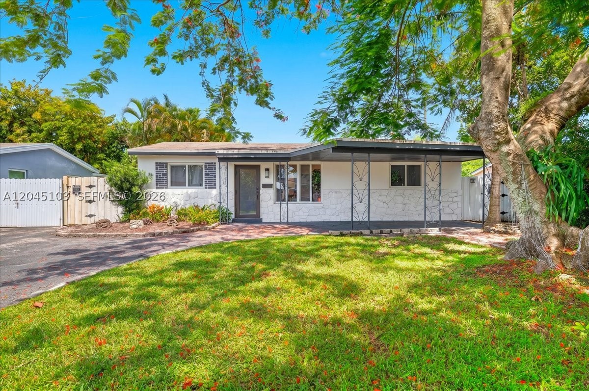 Substantially remodeled and move-in ready, this single-story concrete-block home sits in Hollywood's established Boulevard Heights. The open-concept layout showcases a renovated kitchen with white shaker cabinetry, quartz countertops, a large peninsula , and stainless steel appliances, flowing into bright living and dining spaces with wide-plank flooring throughout. Three bedrooms plus a versatile Florida room/den deliver flexible space for a home office, gym, or guest area, while the primary suite makes for easy single-level living. Built for Florida peace of mind with impact windows and impact doors, an updated roof (2016) and A/C, and a new LG washer/dryer. Enjoy a fully fenced backyard with room for a pool, plus covered parking and a driveway. No HOA. Flood Zone X. Minutes to the Hard Rock, FLL Airport, beaches, shopping, and major highways, a true turnkey opportunity on a sidewalk-lined street. Professional photos available July 7th