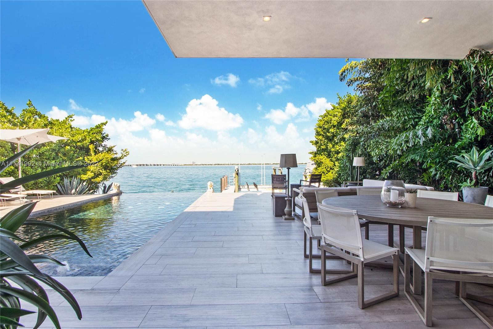 Sleek, Modern, Beautiful Masterpiece in the highly coveted Venetian Islands. Unobstructed, Wide Water Views of
Biscayne Bay and Rooftop Deck affording 360-degree views of the Miami Skyline. This open concept home with lux interiors, has 5 bedrooms each with en suite baths. The double height living area with floor to ceiling doors bath the home in sunlight. The home was designed to blur the lines of indoor/outdoor living. Tasteful terrazzo floors throughout along with smart technology along with an open Italkraft custom kitchen make this home ideal for entertaining. Cruise up to the new dock with new boat lifts on 60ft of water frontage and enjoy the most beautiful view Miami can provide from your infinity pool. This Venetian home is the epitome of the highly sought-after Miami lifestyle.