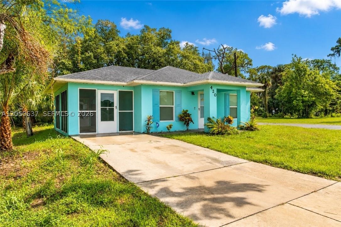 Charming LaBelle Cottage on a Corner Lot! This darling concrete block cottage offers approximately 1,000 square feet of comfortable living space and is ideally situated on a comer lot with paved road frontage on two streets. Built in 2010, the home features a durable shingle roof, a 2022 HV AC system, and a convenient location with easy access to LaBelle, Clewiston, Fort Myers, Lehigh Acres, and surrounding areas. A welcoming 6' x 8' front porch leads into the open-concept living, dining, and kitchen area, creating a bright and inviting space for everyday living. The home also features a spacious 1 0' x 19' screened porch on the south side, accessed through the living room, providing the perfect spot to relax, entertain, or enjoy the Florida breeze. The thoughtfully designed floor plan includes two generously sized bedrooms, each with oversized closets, a handsome full bath with shower, and a separate laundry room that also houses the home's mechanical systems for added convenience. A unique feature is the man door leading to the screened porch, complete with a built-in cat door for your furry family members. Whether you're looking for a starter home, seasonal retreat, or investment property, this well-­maintained home offers affordability, comfort, and a convenient location in the heart of Southwest Florida.