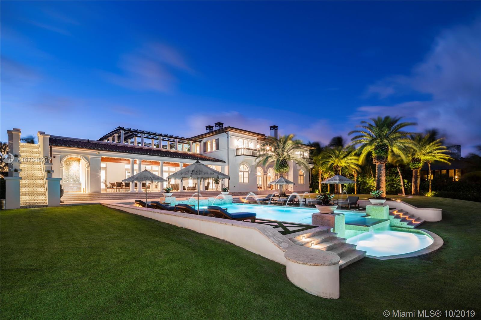 This majestic Tuscan-inspired villa, designed by Rafael Portuondo with the finest finishes and smart technology, is situated on 62,000 SF in prestigious Gables Estates. It boasts 200 ft directly on Biscayne Bay, plus 200 ft on a protected inlet with private dock and boatlift. An entry foyer with marble staircase leads to formal living room and adjacent office. Gourmet kitchen comes with two marble islands. Family room has wet bar in Macassar wood, and wine room has 2,200 bottle capacity. Grand primary suite on second floor has morning bar, two custom closets, and sophisticated primary bathroom. Covered patio includes a summer kitchen and sitting area overlooking an infinity pool with a waterfall. Truly a unique property in a spectacular setting, with wonderful breezes off the Bay.