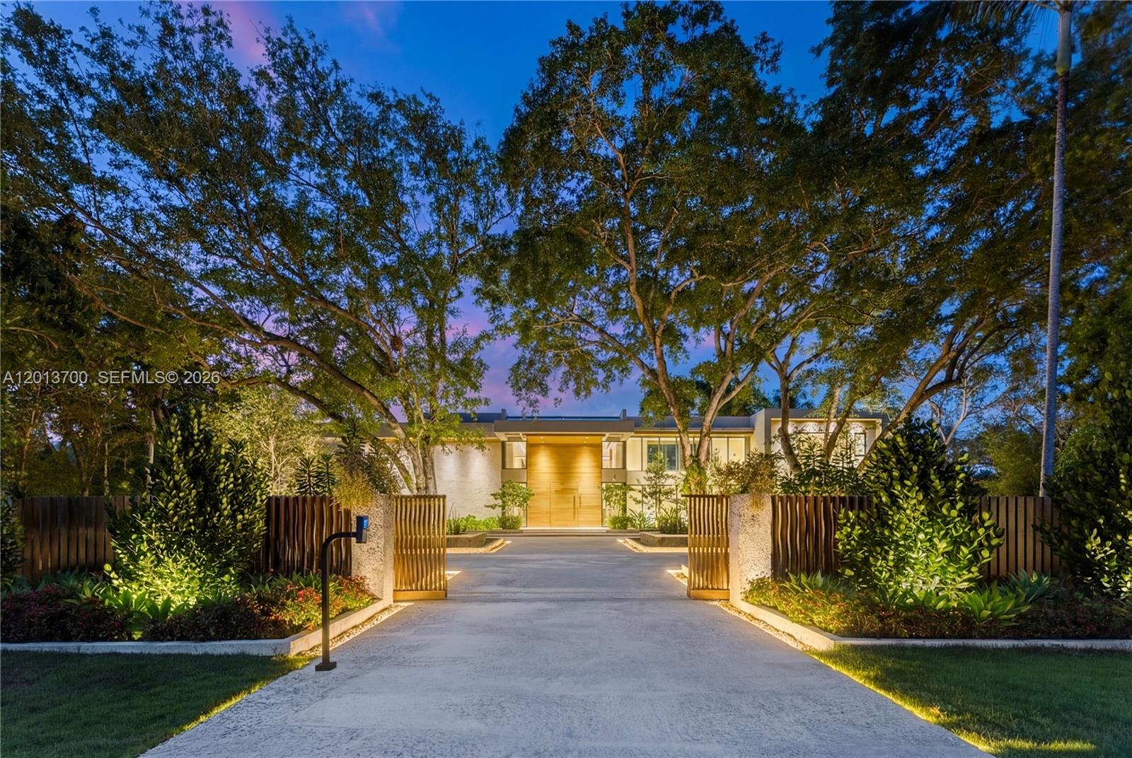 Crestpoint Estate represents a rare convergence of architecture, resort-scale amenity and artistic vision, privately set behind a parametric entrance on a 55,000+ square foot estate in the heart of Pinecrest. Spanning over 16,000 total square feet, the residence offers 7 bedrooms and 8.5 bathrooms, defined by a refined palette of oolite stone, cumaru wood, and venetian plaster.
A dramatic, LED-lit entry court sets the stage for arrival, leading to a grand double-height foyer anchored by a sculptural walnut floating staircase. Natural light defines the interiors, highlighted by a signature sloped skylight over the great room and a glass-lined corridor framed by lush tropical gardens, seamlessly blending indoor and outdoor living.
The Fendi-designed kitchen overlooks the expansive grounds, while the formal living and distinguished entertainment room features bespoke Hermès leather accents. Outdoors, a double-height cascading granite waterfall as a striking focal point alongside a sunken fire lounge, Sukabumi stone pool, putting green, and curated landscaping. Furnished by Artefacto, Crestpoint Estate offers a warm, fully turnkey residence designed for refined entertaining and everyday living.