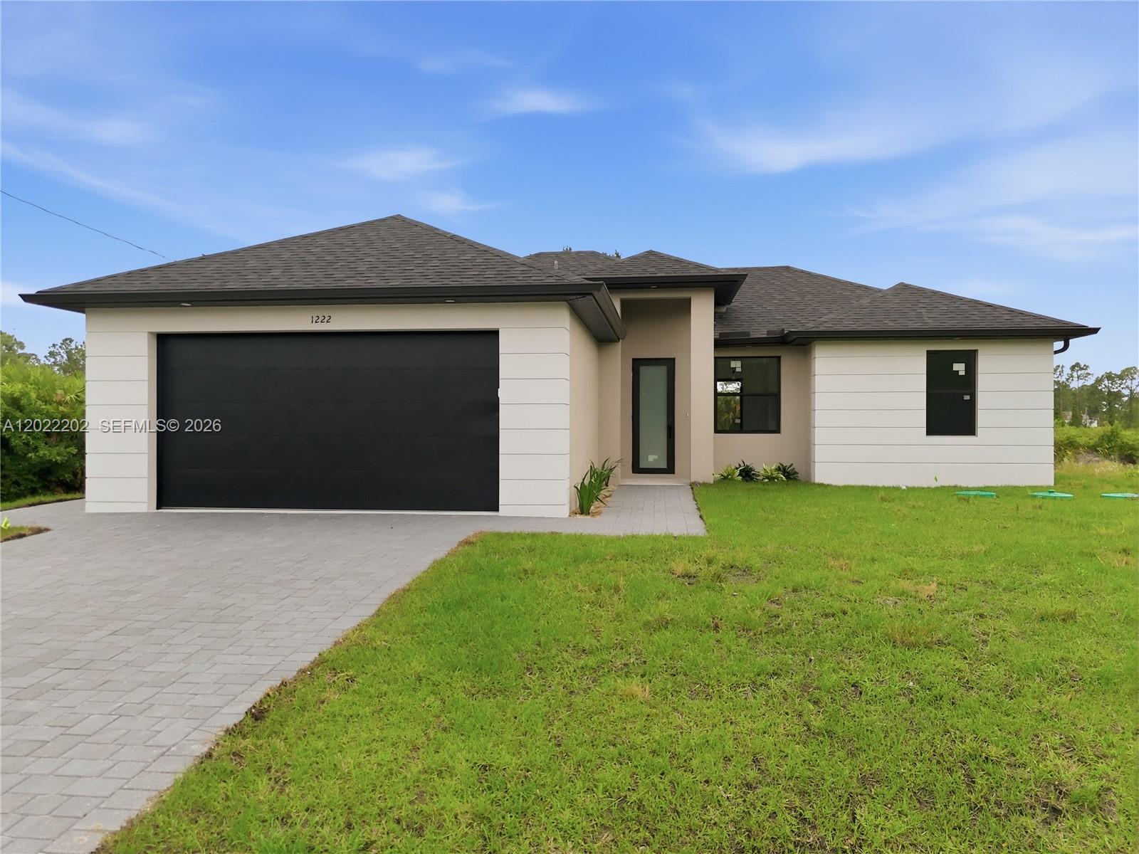 Discover modern canal-front living at its finest at 1222 Earnest St E in Lehigh Acres! This beautifully designed 3-bedroom, 2-bath home offers 1,357 sq ft of stylish luxury with high-end finishes throughout.

Step into a bright, open-concept living space featuring sleek high-gloss acrylic cabinetry, quartz countertops, stainless steel appliances, designer LED lighting, and a custom floating entertainment center with TV included — perfect for entertaining or relaxing in style.

The spacious primary suite serves as a private retreat, complete with dual sinks, floating vanities, LED mirrors, and a stunning walk-in shower with upscale modern finishes.

Enjoy peaceful southern-facing canal views right from your backyard and experience true waterfront living. Whether you enjoy fishing, relaxing outdoors, or simply taking in the serene setting, this property offers the perfect Florida lifestyle.

Every detail of this home was thoughtfully selected to create a sophisticated, contemporary feel that truly stands out from the rest.

Seller is offering up to $10,000 toward buyer closing costs or an interest rate buy-down with a full-price offer, making this an incredible opportunity for buyers seeking style, comfort, and value in one exceptional home.