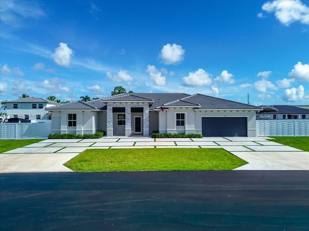 BRAND NEW pool! Resort style built in 2024, this stunning 5BR/4.5BA home offers 3,257 adj. sq. ft. of modern living. Features include a foyer grand entry, open floor plan with large modern kitchen, bright white cabinets, quartz counters, top of the line stainless appliances. Large family room, living room and dining area.  Spacious primary suite boasts walk in closet and spa-like bath. Interior laundry with easy access. Enjoy entertain inside our outside under a covered summer kitchen with full appliances and bar seating, large pool and patio area. Privacy fenced backyard and large storage shed. Extra features include a large canvas covered boat or RV storage and expansive concrete side area for additional parking. Beautiful curb appeal entrance with concrete circular drive with artificial turf. Located in a quiet neighborhood.