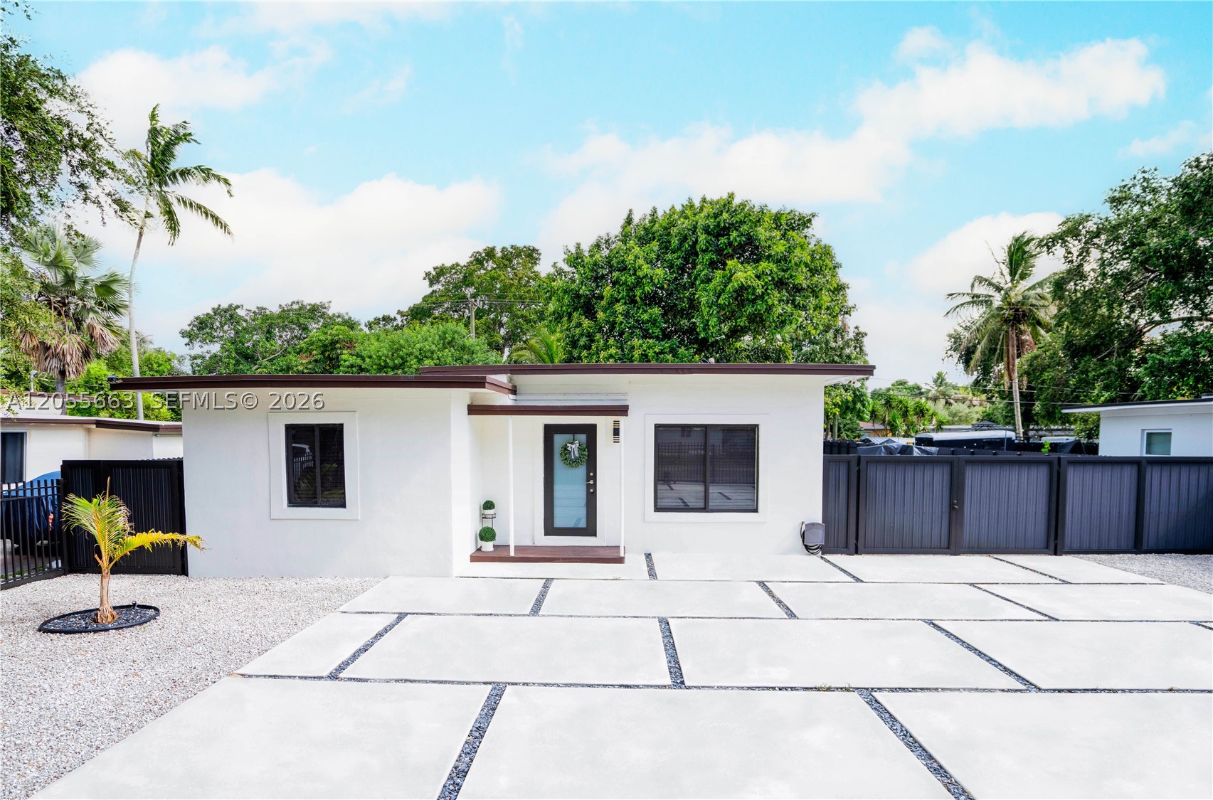 Beautifully renovated modern home on an oversized, fully fenced lot. Features an open-concept layout with large-format porcelain floors, a custom kitchen with quartz countertops, floor-to-ceiling cabinetry, stainless steel appliances, and a spacious island. The updated bathrooms showcase sleek, modern finishes. Outside, enjoy a custom oversized concrete driveway with plenty of parking, plus a huge backyard with three gated side entrances providing easy access for boats, RVs, trailers, and additional vehicles. A truly move-in-ready home, thoughtfully renovated with quality craftsmanship, pride, and attention to every detail. EASY TO SHOW
