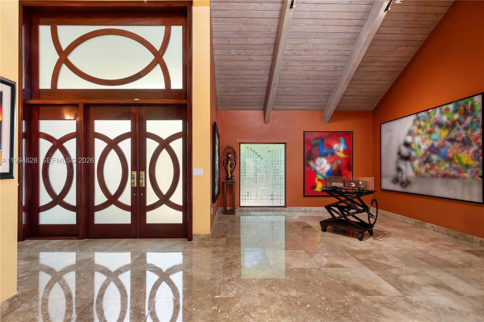 Stunning entry with large mahogany double doors and high ceiling foyer entry. This 5 bedrooms with 5 full and 2 half baths home features a true chefs kitchen by Mia Cucina featuring lighted glass and wood cabinetry, dual sinks, two dishwashers, SubZero refrigerator, Viking gas oven, Miele double oven and an array of extras for the chef in the family. The formal dining room has recessed lighting with wood beam accents. The eat-in kitchen has a view of the courtyard. And, adjacent to the kitchen is a temperature controlled wine cellar holds up to 1900 bottles. The center courtyard is accessible from a variety of different living areas which brings in a lot of natural light throughout. A major highlight is a custom built separate bar room nestled at the end of the courtyard. The courtyard gives entry to a private gate which allows access to the common areas which creates a large backyard feel.The first floor has a possible maids quarters with full bath. Also, a large den that can be used as a  media room. Skylights and mahogany doors are found throughout the house. Space for a private elevator. Upstairs you will find a large master bedroom with a separate sitting area and private sauna. The office and gym can be converted to a large bedroom. The junior suite  has walk in closet with a large bathroom. The private community has a heated pool, tennis courts, pickleball courts, a dog park, security gate, a community center, a park, basketball, and soccer.