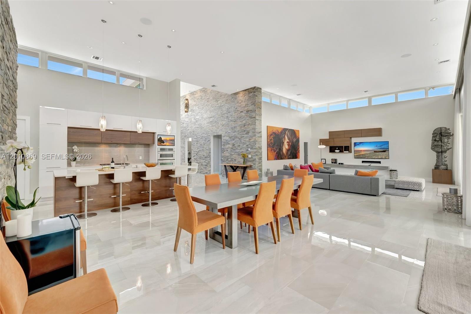 Nothing has been overlooked in 4100SF/AC, modern, luxury living a mile from Aventura & Golden Beach, a 10 minute bike ride to the ocean. ICF construction, (poured concrete walls, not block) for soundproofing, moisture and hurricane protection. Soaring 16 and 20 FT ceilings, impact glass, an abundance of natural light, 5 large beds, 6 full baths, split floor plan on a huge 15,000SF lot. Built and meticulously cared for by snowbirds, backing onto the exclusive Shell Bay Golf & CC, an Auberge Resort. Unique 3 car garage, oversized 20X40 pool RESURFACED ‘26, NEW pool heater ‘26, NEW graded roof ‘25, NEW outdoor kitchen system with natural gas ‘26, NEW gutters ‘26. Covered outdoor dining, sound system, security cameras.