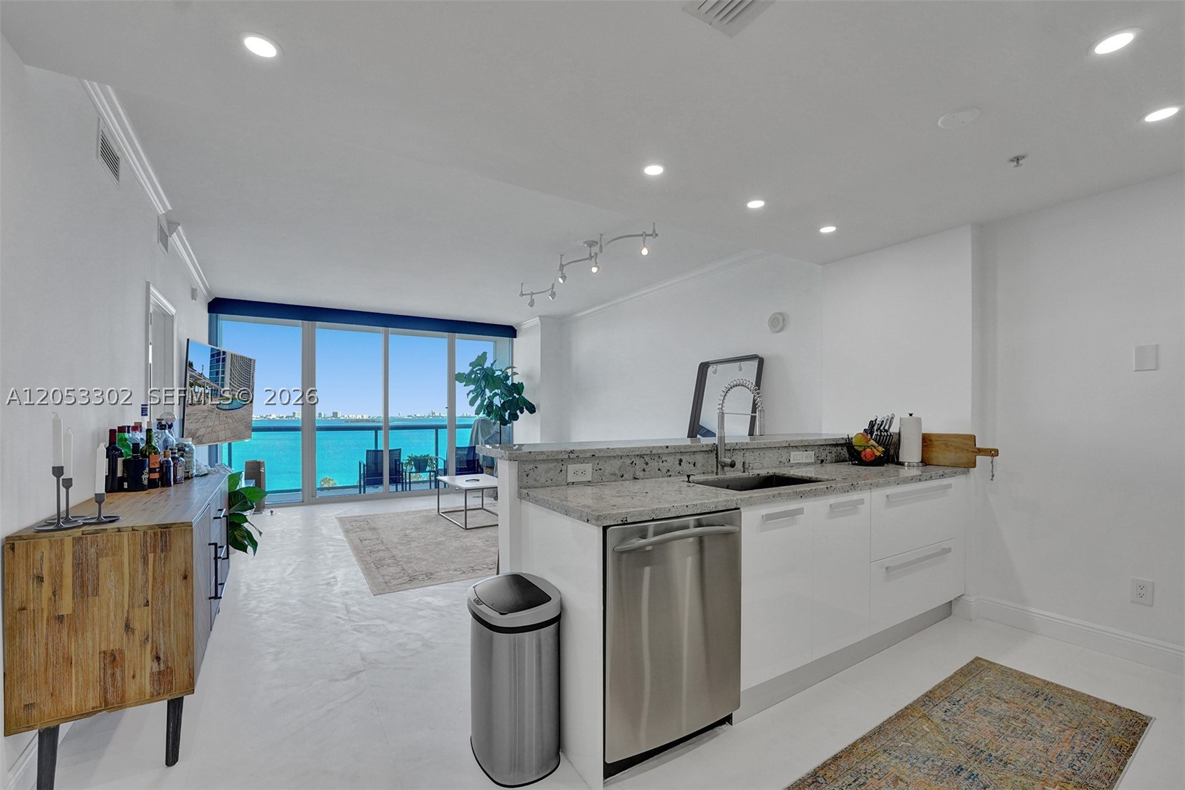 Unobstructed jaw-dropping water views from the moment you step inside the most desirable biggest sqft one bedroom line in the building with upgrades like Black Out and Privacy shades, new washer & dryer in unit, big deep kitchen sink, extended granite countertop, Wood Built-in Master Closet, Master bath includes dual modern sinks huge bathtub/shower combo, limestone marble floors, Italian modern kitchen cabinets with stainless steel appliances. Amenties galore! Front desk 24 hr Security/concierge service, Convenient Store, awesome parking system, multiple heated swimming pools, theatre, party, kids, office rooms. Storage locker. Located in a conveniente area north of edgewater near by is Wynwood, Design district,Miami Beach. Staff makes you feel like family. 2 parking spots!