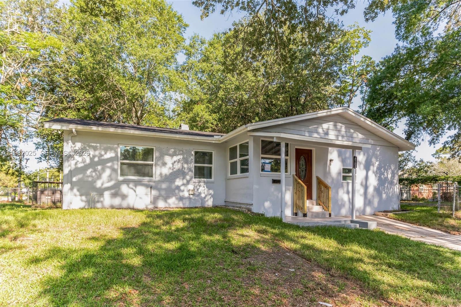Spacious 4-bedroom, 2.5-bath single-family home offering approximately 1,360 sq ft of living space in Northwest Jacksonville. Built in 1958, the home features a functional split-bedroom layout, updated flooring throughout with no carpet, and a bright sunroom at the front entry. The kitchen is equipped with stainless steel appliances, and the home also includes a separate indoor laundry area for added convenience. Situated on an approximately 5,200 sq ft interior lot with a long driveway providing off-street parking for multiple vehicles. Conveniently located near major roadways, Downtown Jacksonville, and local amenities.