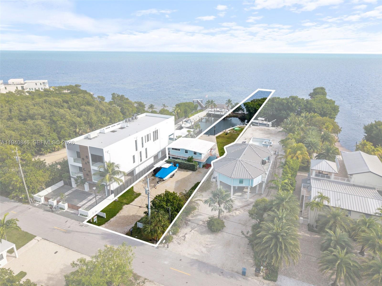 Ocean views, deepwater dockage, it is being replaced 6/2026, and the rare ability to legally operate nightly rentals. This exceptional oceanfront duplex offers a standout turnkey investment opportunity, combining the perfect trifecta for your portfolio: panoramic ocean views, deepwater dockage, and approved nightly rental capability. An ideal multi-family compound and a rare chance to own a fully versatile, income-producing Keys property. Enjoy oceanfront living with two beautifully updated units, each featuring 2 bedrooms and 1-bathroom, separate entrances, and its own oceanfront porch. Boating enthusiasts will appreciate the 100 feet of concrete dockage with immediate ocean access, along with the unique benefit of ownership of the ocean bottom, offering added value.  Zoning permits rentals with a minimum stay of just one night, giving you maximum income potential or the option to enjoy it as a private getaway. Whether you're looking to expand your investment portfolio or create your future oceanfront dream home, this duplex offers unmatched versatility and incredible potential in a beautiful setting. Plenty of parking and room for a pool, expansion or redevelopment!