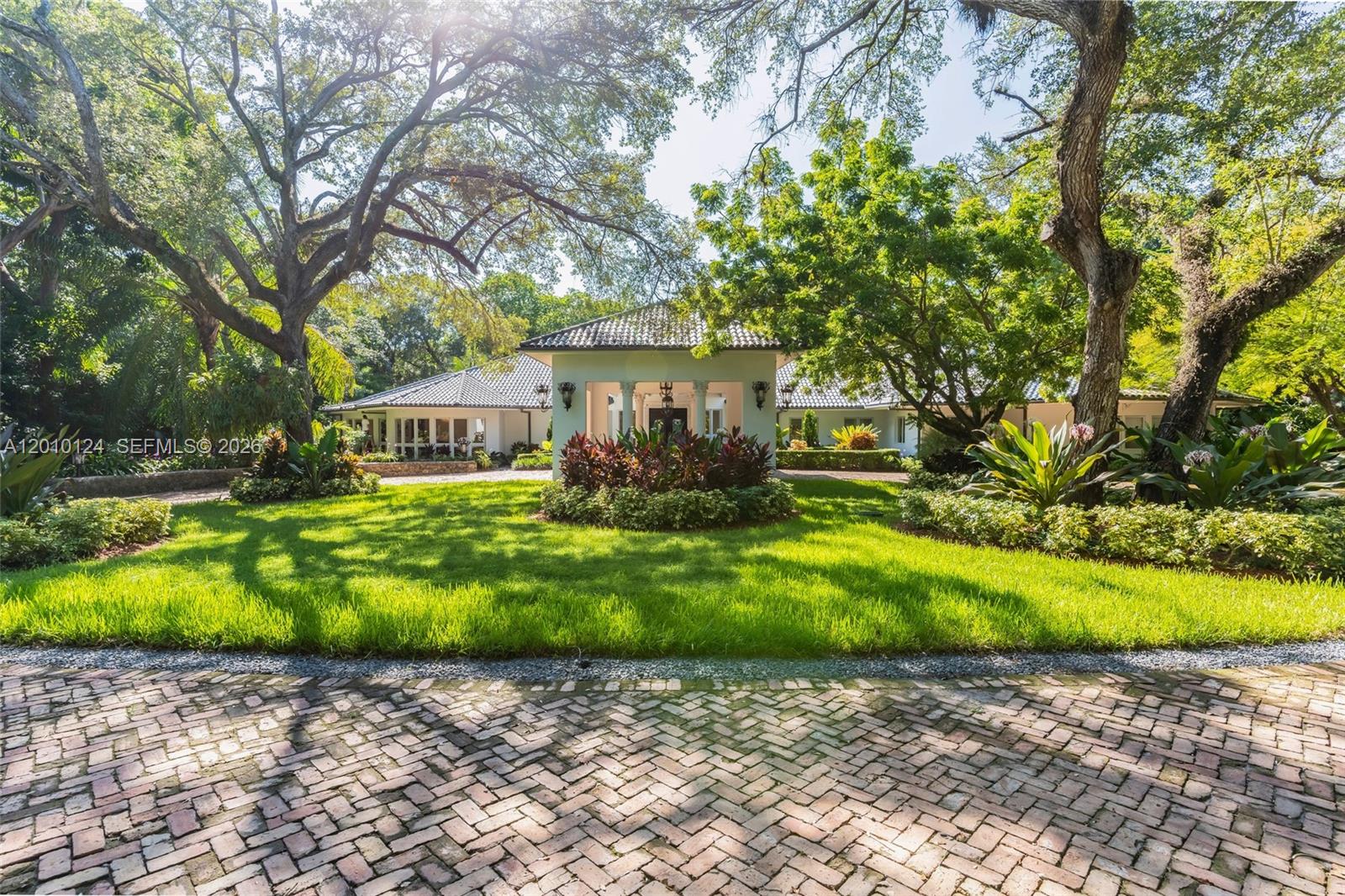 Behind the gates of Villa De Old Cutler awaits a grand one-story estate on 1.51 acres in iconic South Coral Gables! Upon entry you’re greeted with lush gardens, a sweeping Chicago brick driveway, and 8,226 sq ft of luxury living. Built for unforgettable entertaining, it boasts expansive living areas, a gourmet chef’s kitchen, and a massive family room with full wet bar that overlooks your backyard. All 6 bedrooms are ensuite, including a primary suite with its own salon, massive walk-in closets, and oversized bedroom with seating area. Outdoors, enjoy the summer kitchen under expansive covered terraces, and a resort-style pool with waterfall. This is Coral Gables Living at its finest address and location!