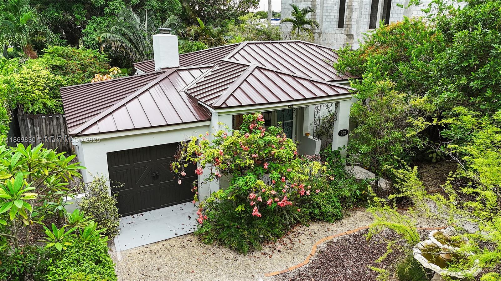 Located in one of Miami Springs’ most desirable neighborhoods, this residence offers charm and long-term value. A METAL ROOF delivers decades of durability, energy efficiency, and reduced insurance costs. Set on a rare OVERSIZED 10,148 sq ft lot, the property offers ample room to expand, add a pool, or design your dream backyard. Inside, bright and inviting living spaces feature a cozy fireplace and architectural details. Accordion shutters, a garage, and lush landscaping add function and curb appeal. Perfectly positioned near Miami International Airport, Miami Springs Golf & Country Club, and the shops and dining of Downtown Miami Springs, this home is also zoned for highly rated schools. This home that balances timeless character with modern upgrades in a sought-after community.