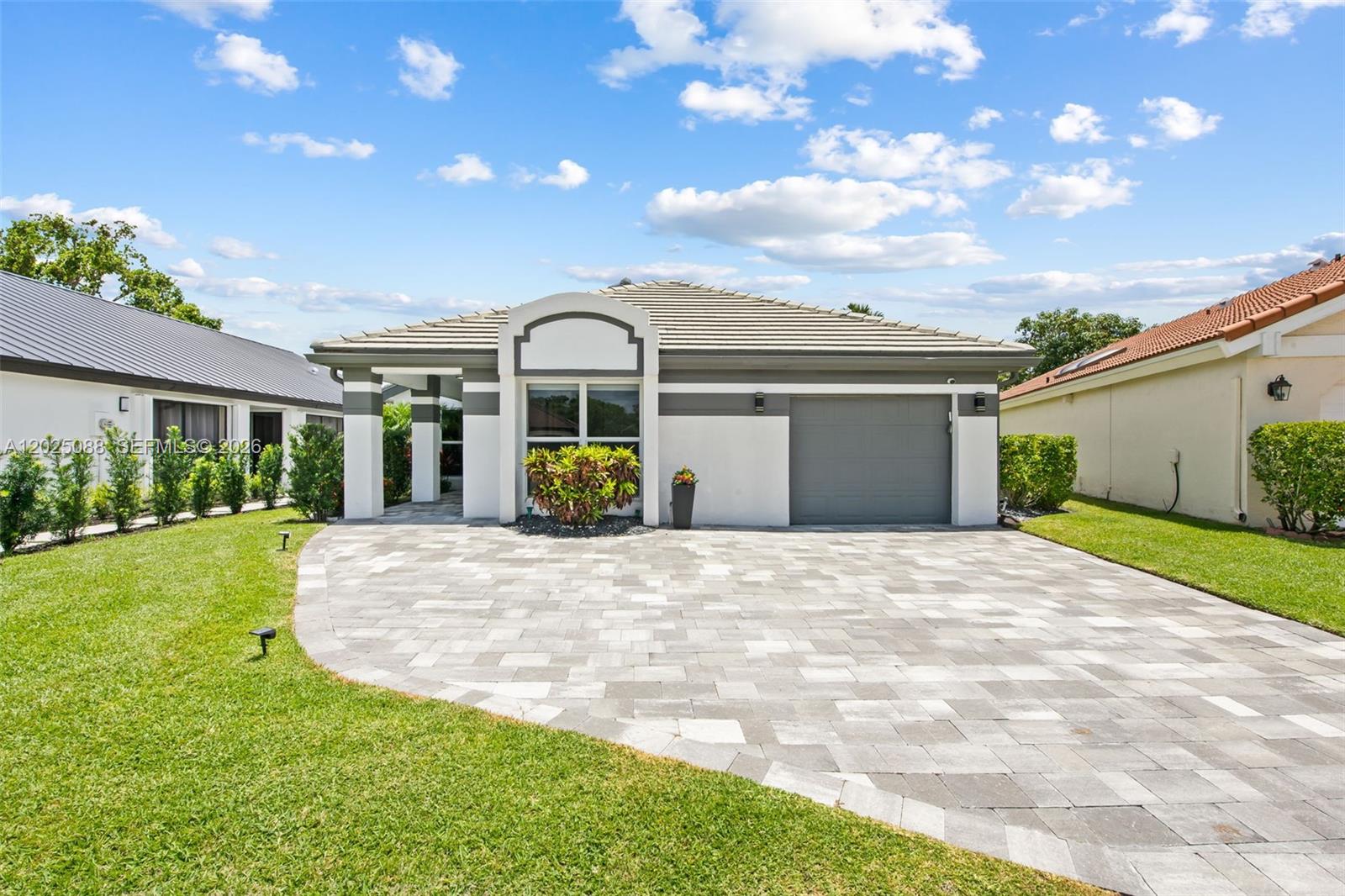 This fully renovated residence blends refined design with exceptional craftsmanship, offering a move-in ready opportunity in the prestigious community of Boca Woods Country Club. Over $200,000 in upgrades, this home is ideal for buyers seeking a beautiful property without the time, stress, or expense of taking on a renovation project. Every detail was thoughtfully selected with quality in mind, from the premium appliances and designer fixtures to the flooring, lighting, impact windows, and updated mechanical systems. Vaulted ceilings create an open atmosphere throughout the home, while the expanded chef’s kitchen serves as the centerpiece for both everyday living and entertaining. Currently configured as a spacious 2-bedroom layout, the home can easily be converted back to a 3-bedroom floor plan. Additional upgrades include a whole house generator with an underground propane tank. All renovations were completed by licensed contractors with permits. Boca Woods Country Club features two championship golf courses and exceptional practice facilities including Toptracer technology, chipping areas, and pristine putting greens. No golf membership waiting list so owners can begin enjoying the courses immediately. Fitness center and spa were recently renovated and offer state of the art equipment, Pilates reformers & professional trainers. Tennis courts and pickleball courts are included as well. Experience luxury, comfort, and resort style living in a premier country club community!