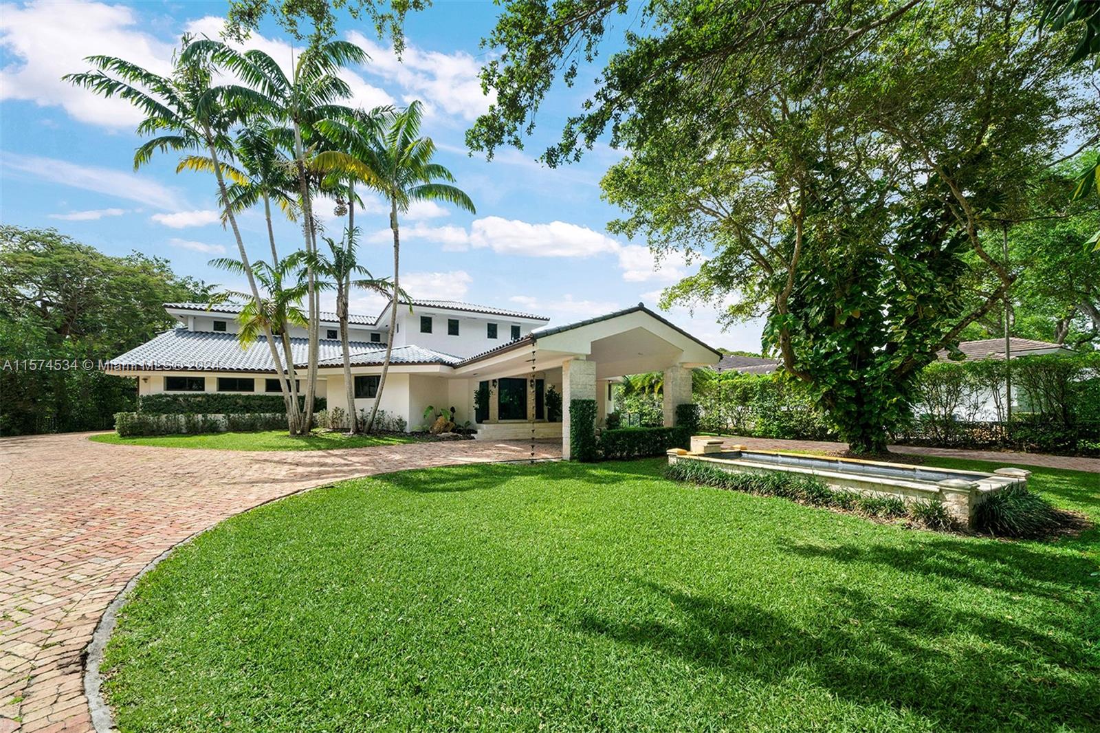 Discover an impressive one-story home in North Pinecrest with a tennis court. Welcomed by a grand foyer leading to a spacious formal living room with high ceilings, creating an inviting atmosphere. Discover spacious entertaining areas: formal dining, cozy breakfast nook, and open-style kitchen connected to a large family room. The family room boasts a convenient built-in bar and enjoy a home theater room on the second level for entertainment. Retreat to the renovated master suite with a spa-like bath and private outdoor deck. The backyard offers a tranquil ambiance with a pool, tennis court, and summer kitchen. Other features include a versatile playroom, impact windows/doors, and proximity to top-rated schools.