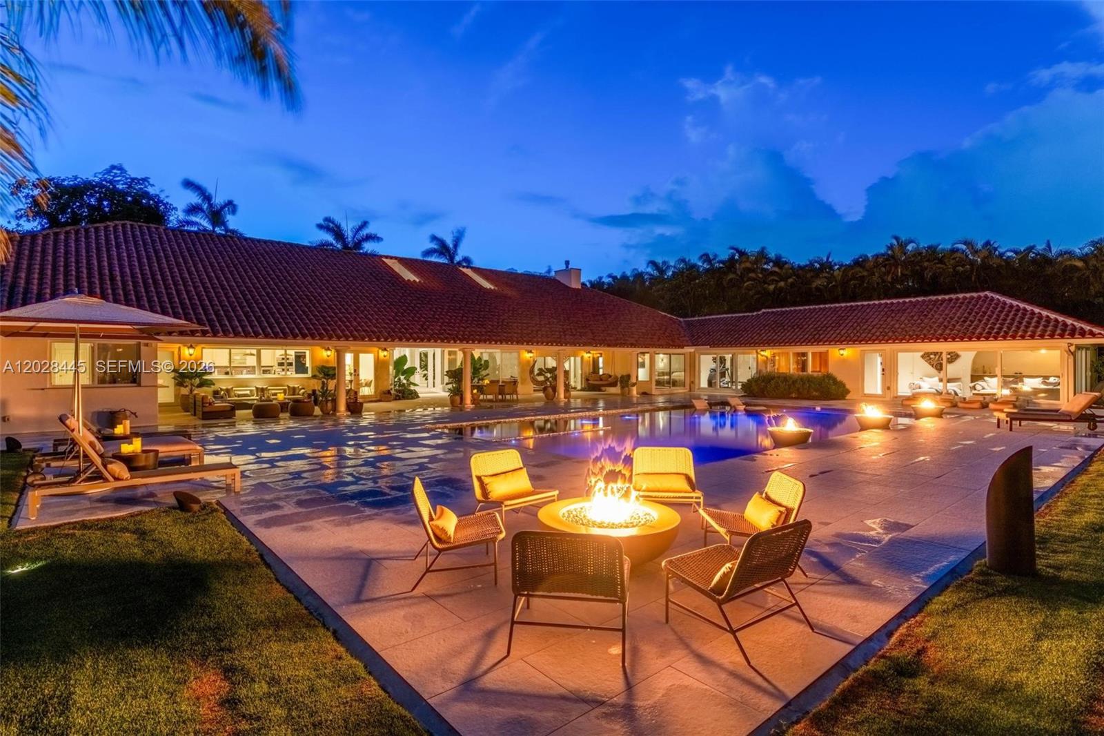Nestled along historic Old Cutler Road in the heart of Coral Gables, this gated custom estate offers exceptional privacy on lushly landscaped grounds. This fully furnished single-story residence features 6 bedrooms, 6 bathrooms, and an expansive split-bedroom floor plan designed for both comfortable living and effortless entertaining. Elegant interiors showcase soaring vaulted ceilings, marble and hardwood flooring, spacious formal living and dining areas, a family room, private office, wine cellar, and abundant natural light throughout. The gourmet kitchen opens to a spectacular covered terrace with a wet bar, creating a seamless indoor-outdoor lifestyle. A standout feature of the property is the private wellness center, complete with a gym, sauna, and cold plunge, offering a true spa-like experience at home. Outside, enjoy a resort-style pool, mature tropical landscaping, and expansive entertaining areas that create a private oasis in one of Coral Gables' most coveted locations.