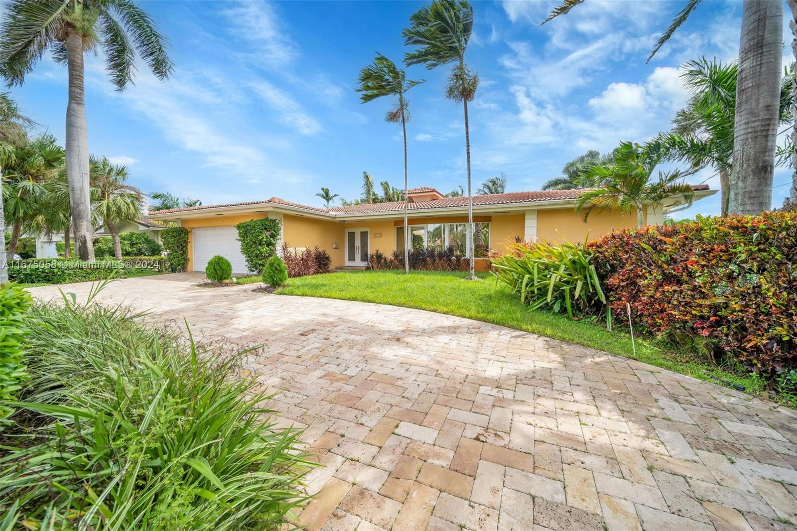 Nestled on a quiet cul-de-sac, this beautifully updated 4-bedroom, 3-bath home offers 3,554 sqft of living space and is a boater’s dream with no fixed bridges to the ocean. It features a concrete dock, an updated seawall, and a 12,000lb boat lift. The kitchen showcases cherry and blonde maple cabinets, granite countertops, and convenient pullout drawers throughout, perfect for any cooking enthusiast. The split-bedroom layout provides privacy, with an office/den that can serve as a fourth bedroom. Enjoy seamless indoor-outdoor living with a spacious patio featuring skylights and LED lighting, ideal for entertaining. The large air-conditioned two-car garage and the beautiful pool area, complete with a pergola, make outdoor dining a breeze.