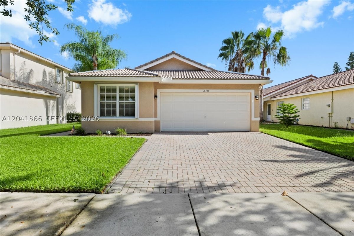 Welcome to this lovingly maintained, one-owner home, offered for the very first time in one of the area's most desirable gated communities. Filled with warmth and pride of ownership, this residence offers an open and inviting layout with soaring vaulted ceilings, abundant natural light, and serene water views.

The spacious kitchen flows seamlessly into the family room, creating the perfect setting for everyday living and entertaining. Versatile fourth bedroom currently being used as a home office, but can be used as a playroom, or additional living area. The generous primary suite offers peaceful lake views and a well-appointed bath, while the split-bedroom floor plan provides comfort and privacy for family and guests alike.

Enjoy your private backyard retreat overlooking the water, where you can relax and enjoy South Florida's beautiful sunsets year-round. Conveniently located near excellent schools, parks, shopping, dining, and major highways, this exceptional property combines comfort, location, and timeless appeal.

A special opportunity to own a home that has been cherished by the same family since day one.