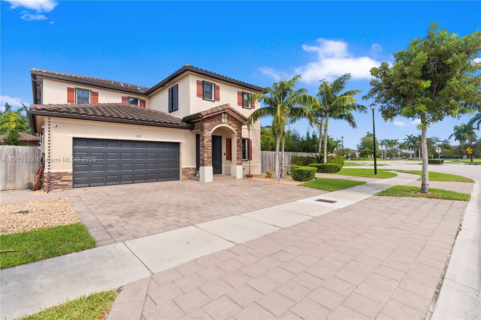 Located in the highly desirable Artesa community, this elegant residence offers exceptional comfort and convenience just minutes from the Turnpike. The community features a clubhouse with a gym, playground, pool, and multiple pavilions, ideal for gatherings and events. Positioned on a spacious corner lot, this next-gen home includes 5 bedrooms and 3.5 bathrooms, featuring a private in-law suite on the first floor for added accessibility. The property is appointed with premium finishes, including tile flooring throughout, a gourmet kitchen with granite countertops, custom wood cabinetry, and top-of-the-line stainless-steel appliances.