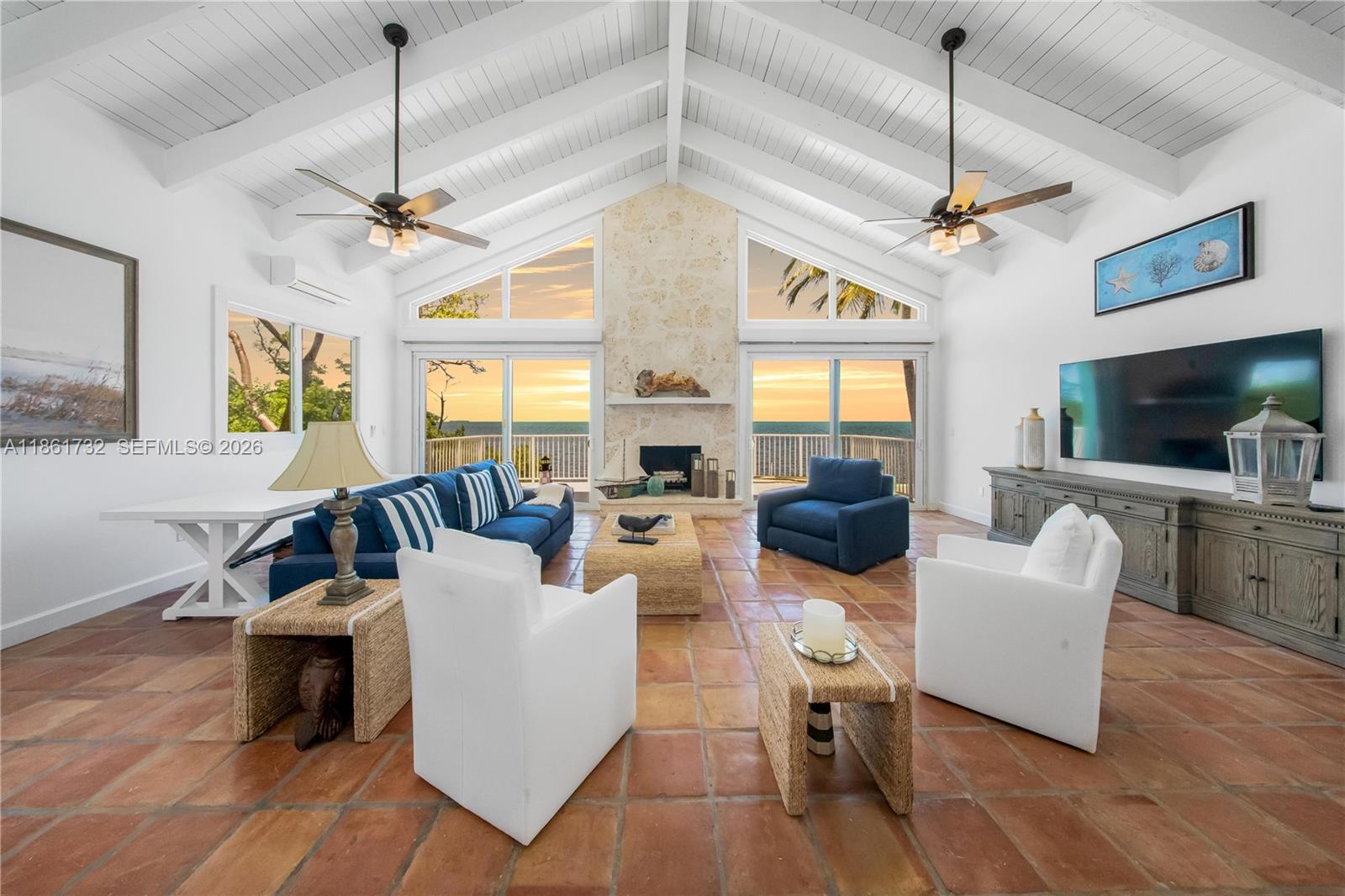 Simply the best location, exclusive & extremely private. It's tucked away in the prestigious "Plantation Lake Estates," a highly sought-after gated community with an on-site boat ramp and park. This Coastal-Styled Beach Home is in a prime location at Mile Marker 87, across the street from Founders Park, which has a beach, tennis courts, a full-service marina, a dog park, sports fields, and Olympic-size lap pools. This home boasts a stunning great room with a gorgeous coral fireplace and soaring wood beam ceilings. They all overlook the glistening Atlantic Ocean, providing priceless views and sunrises. The home has a modern kitchen and updated baths, as well as impact windows and doors. The exterior has been reinforced with rebar and stucco. There are three inviting bedrooms, including a third-floor primary en-suite with a private porch.