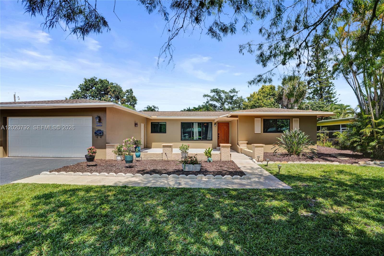 Space, flexibility and major-ticket upgrades come together in this Plantation Park 4-bedroom, 3-bath home with a split floor plan buyers are constantly searching for but rarely find. Multiple living spaces, impact windows and doors throughout and a layout that actually makes sense for real life set this home apart the moment you walk in. The spacious floor plan offers a formal living room, separate dining area and a large family room that all flow naturally into the updated kitchen creating the perfect balance of openness and defined living spaces. One of the bedrooms offers flexible use as a den, office or guest suite with its own bathroom making it ideal for multigenerational living, guests or working from home. The updated kitchen features granite countertops, wood cabinetry and tile flooring throughout the main living areas. The primary suite includes laminate flooring and a walk-in closet while the secondary bedrooms feature classic terrazzo floors that bring character and warmth back into style. Step outside to a spacious screened and covered patio overlooking the backyard with plenty of room to entertain, relax or enjoy the South Florida lifestyle year-round. Major upgrades already completed including impact windows, impact doors and impact garage door throughout, main roof replaced in 2020, flat roof replaced in 2024, water heater is 2020, A/C is 2021 & Electrical Panels 2026. Convenient Plantation location near parks, shopping, dining, major roadways and highways.
