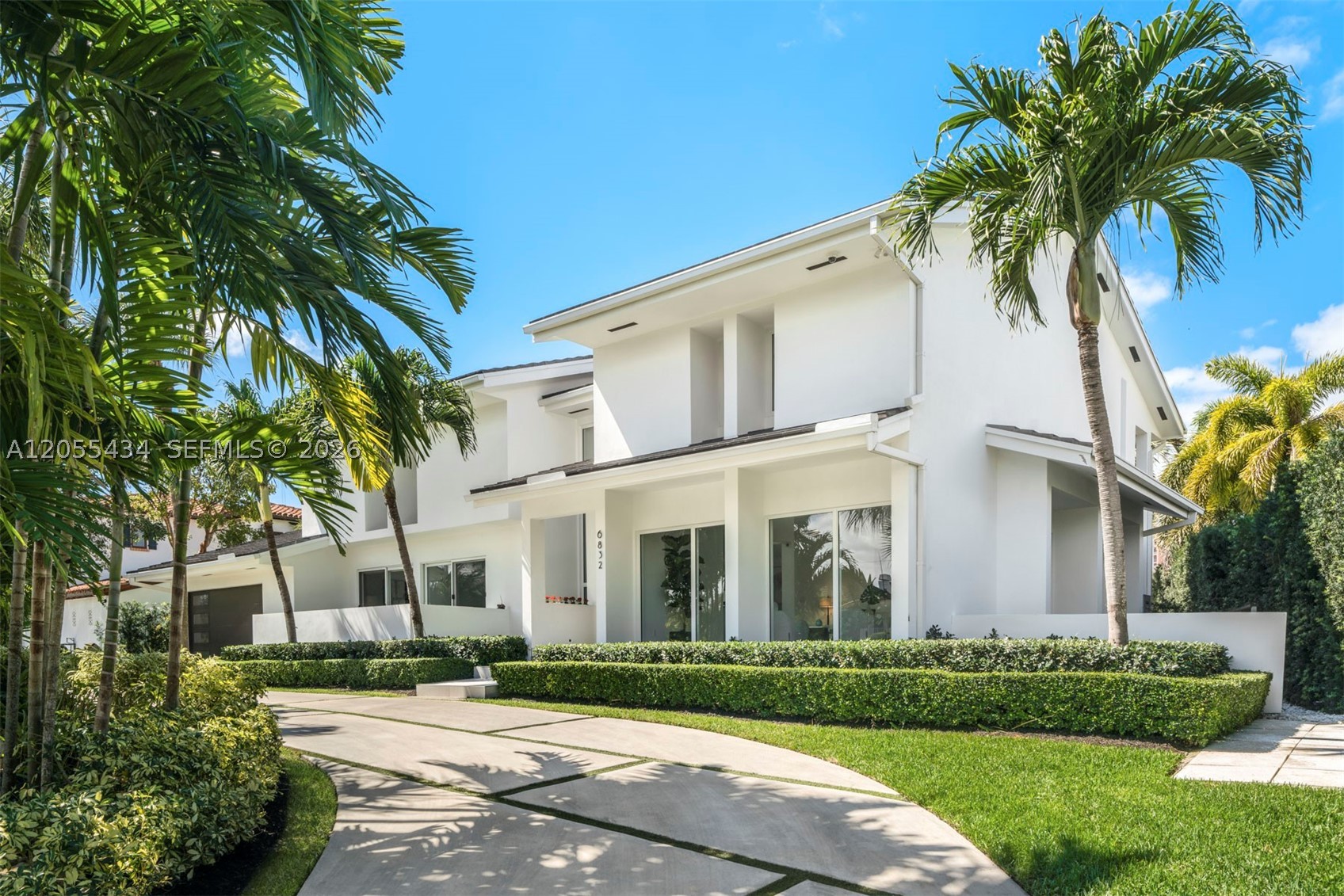 Fully remodeled 6,819 SF waterfront home in the highly sought-after Coral Gables gated community of Sunrise Harbour, with 5 bedrooms and 6 bathrooms on a 14,112 SF lot. Beautifully oriented pavers and manicured landscaping provide stunning curb appeal leading to a grand entry with volume ceilings. The gourmet kitchen includes an oversized island, custom cabinetry, gas range, and top-of-the-line Thermador and Viking appliances. Tastefully remodeled, the residence offers a bright and spacious floor plan accompanied by high-end designer finishes. It also is a true boater’s paradise, with canal-facing pool, dock, and direct ocean access. Additional features include a climate-controlled wine cellar, new roof, impact windows and doors, smart home system, and electric Lutron blinds.