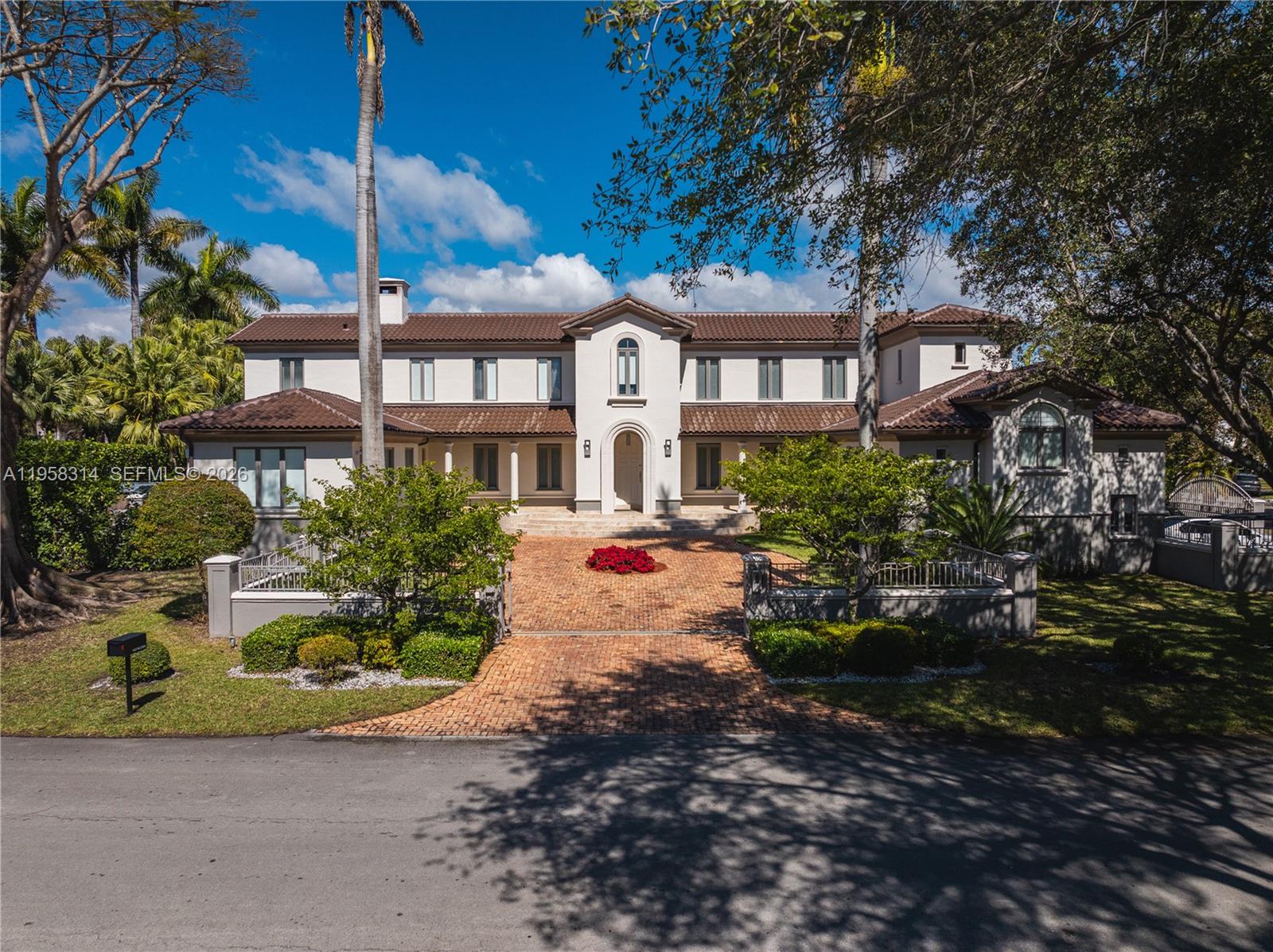Crown jewel of Paloma Dr. on an oversized lot with exceptional privacy and only one rear neighbor. Custom home remodeled in 2016 featuring smart-home technology and contemporary luxury finishes throughout. New roof 2025. Open living and dining areas showcase 39” x 39” Porcelanosa tile floors, dropped ceilings, and expansive views of the outdoors. Gourmet kitchen with Viking and Miele appliances, Calacatta marble island and countertops. Breakfast area opens to family room and covered terrace with outdoor kitchen, pool deck, spa, and large yard. Wine cellar. Two downstairs bedroom with shared bath. Upstairs office opens to primary suite with three custom closets featuring leather finishes and a stunning bath with Bisazza mosaics. Two additional upstairs en-suite bedrooms. Mezzanine staff quarters and storage. Impact windows and doors, two staircases, fireplace, motorized shades, side driveway, and two-car garage. *New Pictures coming soon.