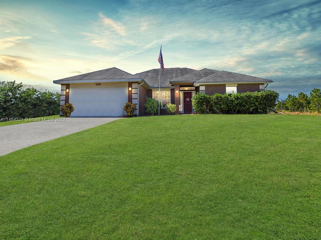 Nestled in the heart of Lehigh Acres, this spacious 4-bed, 3-bath home boasts a 2-car garage and is situated on an expansive half-acre lot. Upon entering, you'll immediately appreciate the open and well-lit layout. The kitchen, featuring stainless steel appliances and a generous island with a breakfast bar, is a culinary enthusiast's dream. Step outside to the backyard area, which offers ample space for outdoor activities and even the possibility of adding a pool. This property is ideally located, providing easy access to all that southwest Florida has to offer. You'll find yourself in close proximity to the region's pristine beaches, renowned golf courses, picturesque nature parks, convenient shopping plazas, and a diverse range of dining options. Call today for your private viewing!