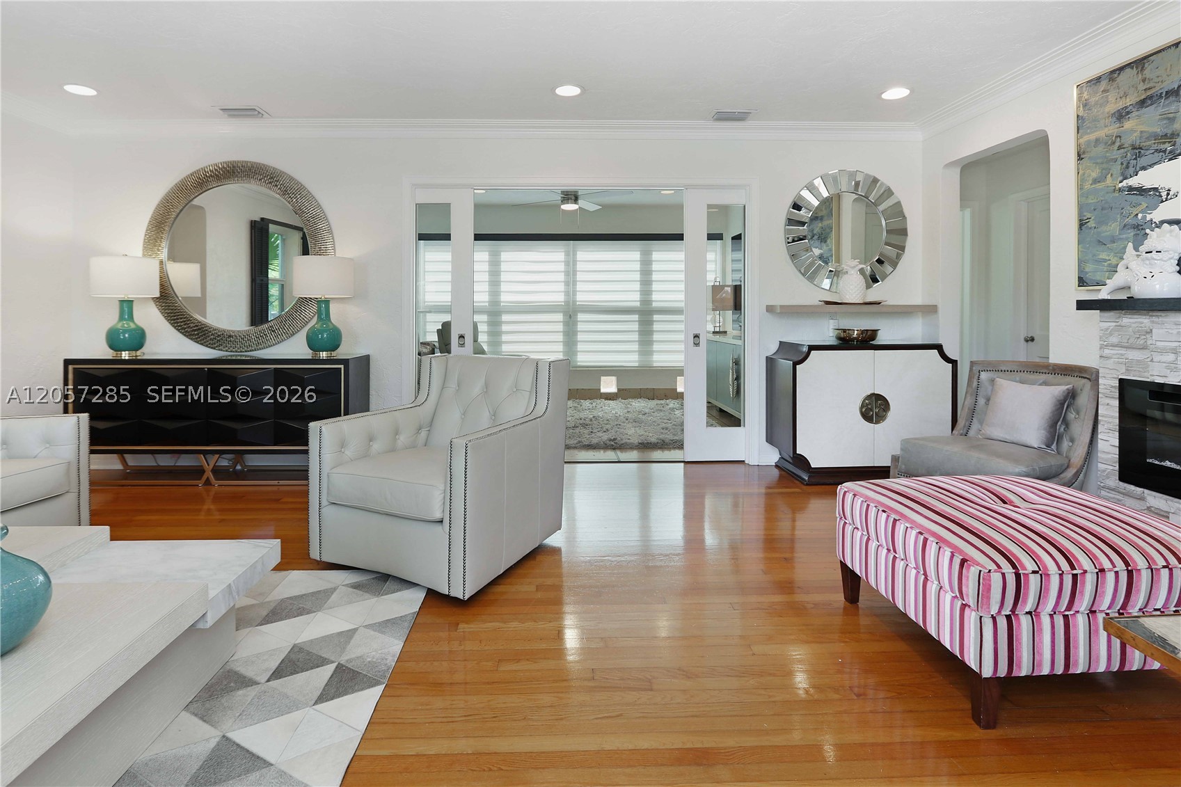 2 bedroom, 2 bathroom Hollywood Lakes home where timeless 1940s charm meets thoughtful modern updates. Rich in character, this beautifully maintained residence features an arched front entry, gated courtyard, restored hardwood floors, original Cuban tile, crown molding, plantation shutters, original sliding doors, and an inviting sunroom with decorative cement tile flooring. The open kitchen is appointed with granite countertops, a mosaic tile backsplash, stainless steel appliances, a gas range, recessed lighting, and a pass-through overlooking the spacious family room. Enjoy multiple living spaces including a formal living room with an electric fireplace, family room, and formal dining room, creating an ideal layout for both everyday living and entertaining.

Recent improvements include a new A/C (2025), new flat roof (2026), new insulation, custom blinds, new ceiling fans, updated electrical switches, and a new two-zone sprinkler system. Outside, the beautifully landscaped grounds feature fresh sod, a charming front courtyard, a gazebo, a recently resealed fenced backyard, a covered carport, and a one-car garage with a hurricane-rated garage door and washer & dryer. Located in the heart of desirable Hollywood Lakes, this home is perfect for buyers who appreciate vintage elegance, quality craftsmanship, and a neighborhood just minutes from the beach, Downtown Hollywood, parks, and dining.