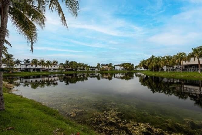Lakefront 3BD/2.5BA townhome in desirable Bluewaters! Enjoy serene lake views from the open patio. Downstairs features tile floors, spacious dining/living room, family room, breakfast nook, and kitchen with snack bar. All bedrooms upstairs with laminate wood flooring. The primary suite offers a tray ceiling, his & her closets, and a water closet. New hot water heater! Paver driveway fits 2 cars, plus guest and street parking. Just minutes to the FL Turnpike, newer schools, shopping, and dining. Only 30 mins to Miami & 45 mins to the FL Keys—ideal for commuters or weekend getaways!