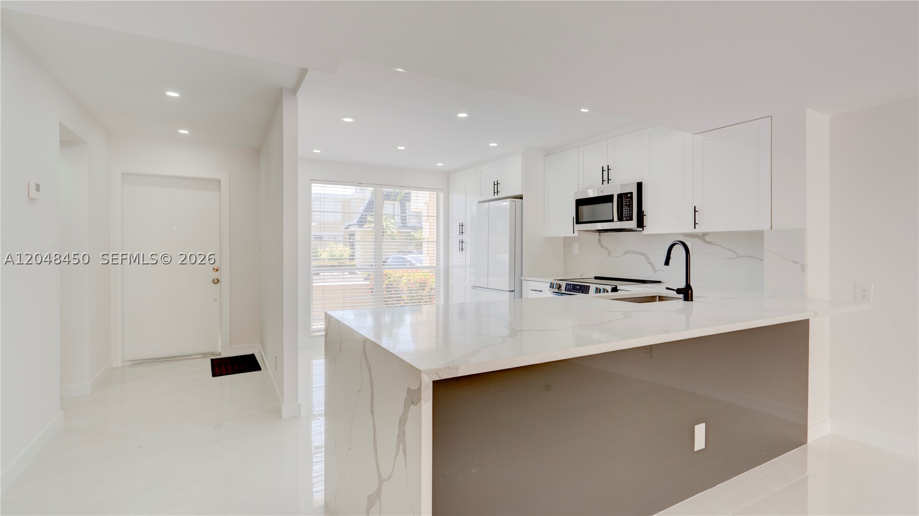 Experience the perfect blend of luxury and convenience in this completely renovated 3-bedroom, 2.5-bath townhouse in a prime location. Bright and move-in ready, this beautiful home features elegant ceramic flooring throughout and a spacious open-concept floor plan ideal for modern living and entertaining. The oversized primary suite offers a large walk-in closet and a beautifully updated bathroom. Step outside to your private oversized patio with direct access to a scenic park featuring walking trails, a children's playground, dog park, fitness stations, and a basketball court. Community amenities include a heated pool, sauna, clubhouse with kitchen facilities, and tennis courts. Two designated parking spaces are conveniently located directly in front of the unit. Additional highlights include a new roof (2024) and an unbeatable location just minutes from the beach, Aventura Mall, Gulfstream Park & Casino, shopping, dining, major highways, and houses of worship. A rare opportunity to own a turnkey home in one of the area's most desirable communities.
