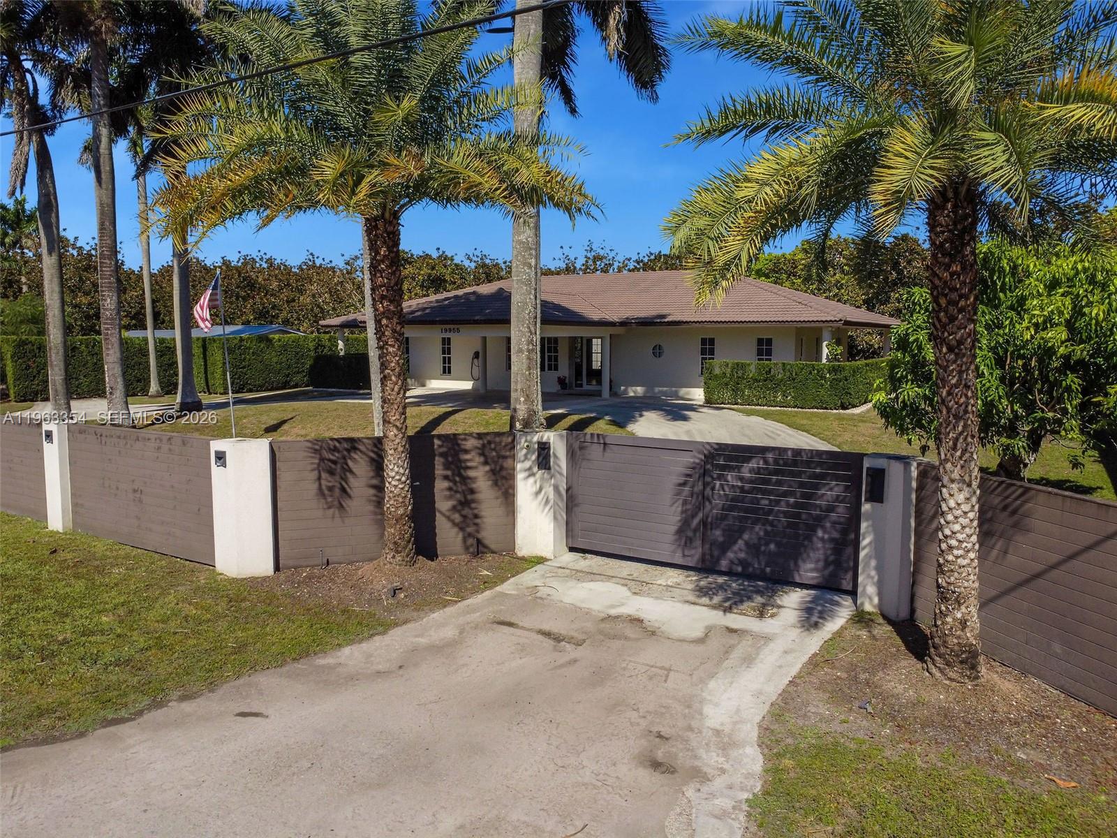 Prime Redlands agricultural compound with in-place income and agricultural exemption situated on 2.38 acres. Total living area is 4,979 SF across three separate structures, fully enclosed by a $200,000 perimeter fence with concrete footings (installed 2020) for maximum privacy and security. The main residence(2,911 sf) is a completely remodeled 3-bedroom, 3.5-bath home featuring 2024 renovations including a new kitchen with custom cabinetry and island, updated bathrooms, new flooring, new millwork and doors, and upgraded plumbing and fixtures. The detached guest house(1,270 sf) offers 3 bedrooms and 2 bathrooms with a new 2024 metal roof. The fully remodeled detached apartment(550 sf) features 1 bedroom and 1 bathroom, also with a new 2024 metal roof. The main house and guest house are separated by hedges and have independent entrances, creating a true compound layout ideal for multigenerational living or rental flexibility. Agricultural income averages approximately $29,000 annually from 165 mature Mamey and avocado trees. Additional income potential includes approximately $3,000 per month from the guest house and $1,500 per month from the apartment. Property features include irrigation system throughout, water filtration system, well and septic, and roof encapsulated in concrete for added durability. Agricultural exemption means low property taxes. Rare opportunity to acquire a turnkey, income-producing agricultural estate in the heart of the Redlands.