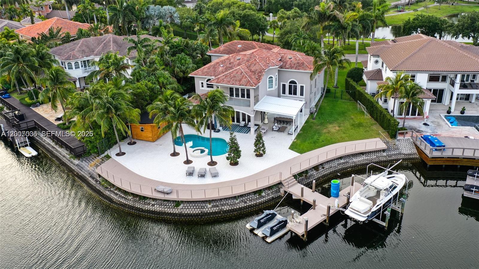 One-of-a-kind house located on a quiet street in "Harbor Estates," the most sought-after neighborhood in the Harbor Islands. One of the best waterfront lots in the community, featuring a custom-built dock that accommodates a large boat. This 6-bedroom, 6.5-bath custom home features exceptional amenities, including a spectacular master suite with a private balcony overlooking the pool and a broad water view, as well as a 3-car garage. The home sits on a 16,110 sf lot. Enjoy amenities and 24-hour security. Steps to a 20-acre park with biking and jogging trails. This luxury waterfront community features a marina, clubhouse, parks, tennis, basketball, and pickleball courts, 24-hour security patrol, and a fitness center. Unlimited guest parking.