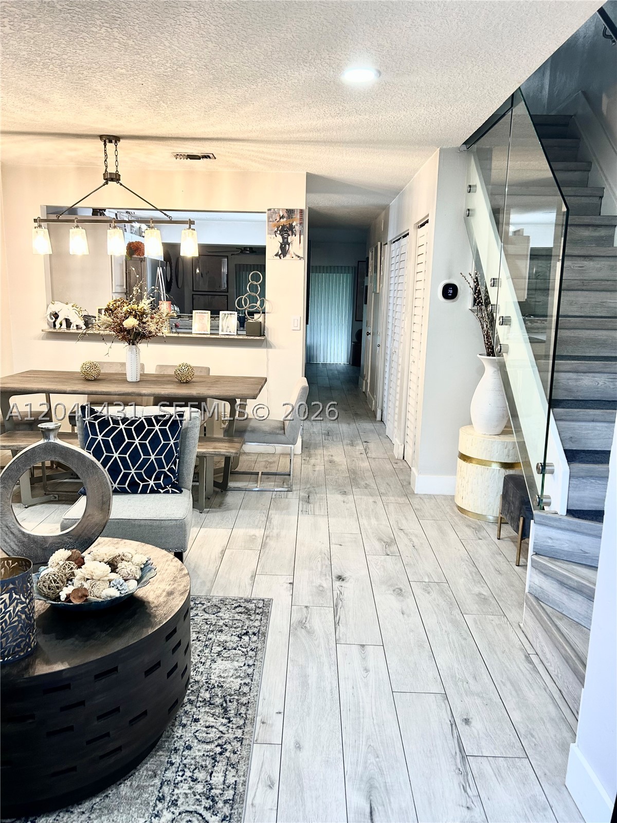 Beautiful remodeled unit with garden view. This townhome is turnkey ready featuring custom glass staircase. Custom glass doors upstairs, alongside custom window treatments (Hunter Douglas shade) and Plantation Shutters.Home has den that can be used as flex space. New A/C unit (Smart Thermostat), Stainless Appliances, New electric Panel, Recess lighting installed throughout the home..Hurricane Accordion Shutters. Kitchen has granite tops with custom wood cabinets. Screened in Patio overlooking garden. Pet friendly community,A Rated schools. Close to shopping and Highway.