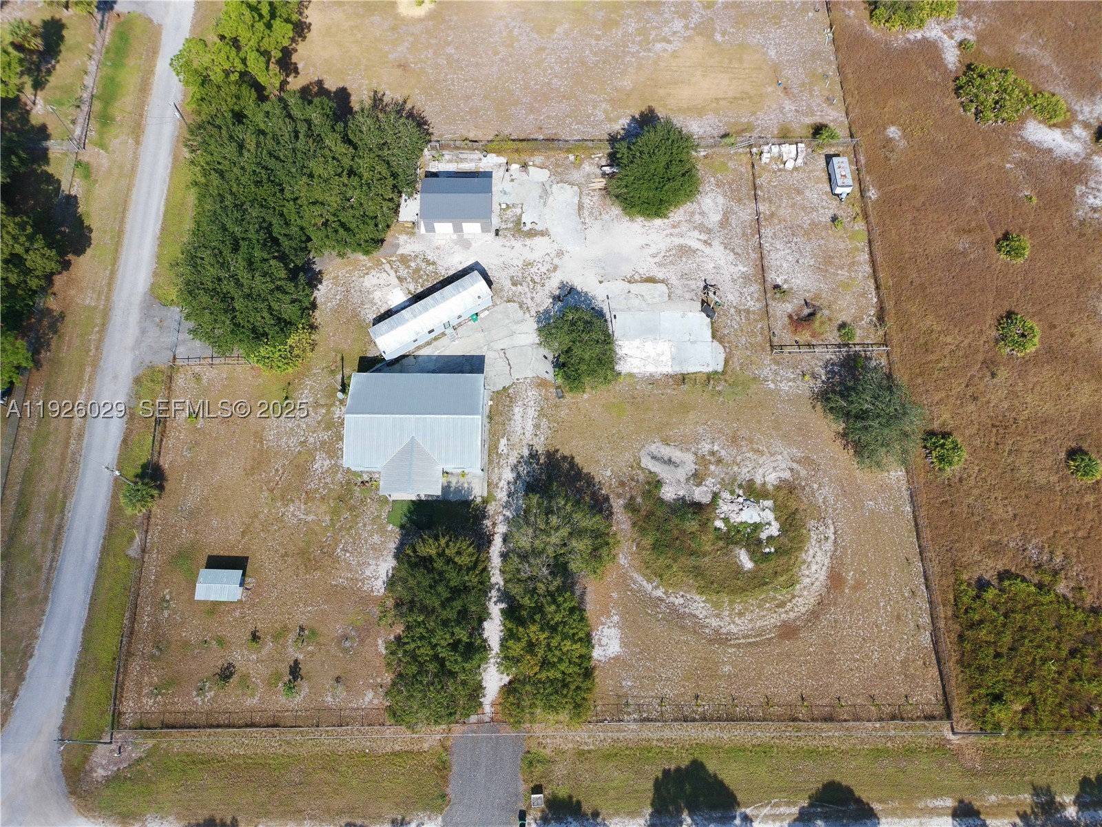 Beautifully remodeled Single Family Home on a peaceful 2.5-acre lot, offering space, privacy, and a true countryside lifestyle. Property features new porcelain tile flooring throughout, fresh interior and exterior paint, and a brand-new A/C unit for added comfort. High-impact windows and doors provide safety, energy efficiency, and hurricane protection.

The property is fully fenced with two large gated entrances, ideal for easy access and added security. A brand-new 30’ x 20’ structure offers great versatility—perfect for storage, workspace, or hobbies. The home is equipped with a well and septic tank, helping to lower utility costs.

Furniture is negotiable for seamless occupancy. A perfect retreat for families looking for tranquility and room to grow. Enjoy the natural surroundings while still having the potential to personalize outdoor spaces.

Mobile home on site does not convey. Property is being sold AS-IS.