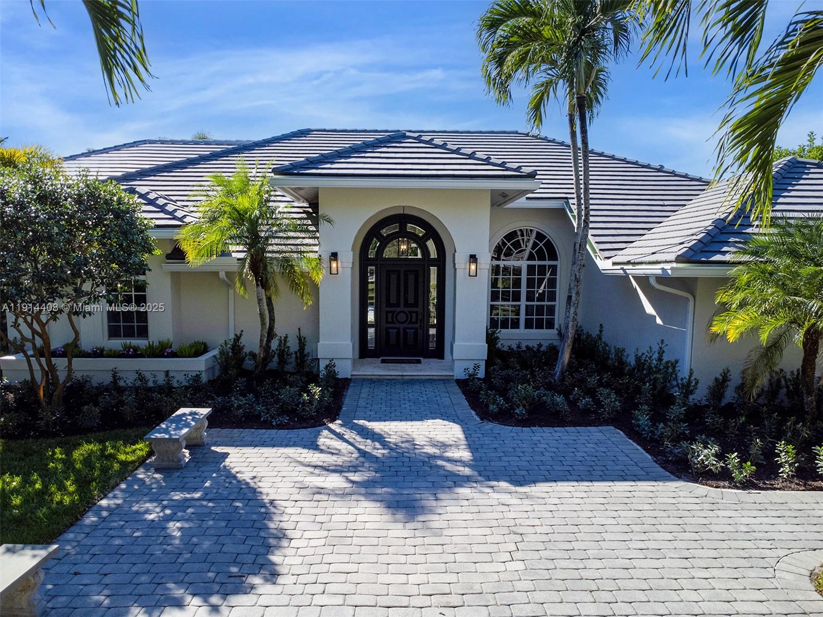 Enjoy luxury and serenity at 7675 Steeplechase Drive—a stunning renovation with new primary suite. This 6-bed, 4.5-bath estate spans over 4,782 sq ft with guest house on a private 1-acre lot in the coveted Steeplechase community. Featuring, contemporary design, modern accents, abundant light, panoramic views. Gourmet kitchen: wood cabinetry, large island, gas stove, quartzite countertops, Thermador appliances—plus caterer’s kitchen with oversized fridge. Primary suite: vaulted ceilings, luxurious bath, dual closets, impact doors to pool. Charming, detached guest house with kitchenette, full bath, Murphy bed, private patio. Heated pool/spa, outdoor kitchen, lanai, new landscaping/irrigation. Roof 2010, 3 new A/C 2022, 2-car garage. This rare Palm Beach Gardens oasis won't last—schedule your private tour today.