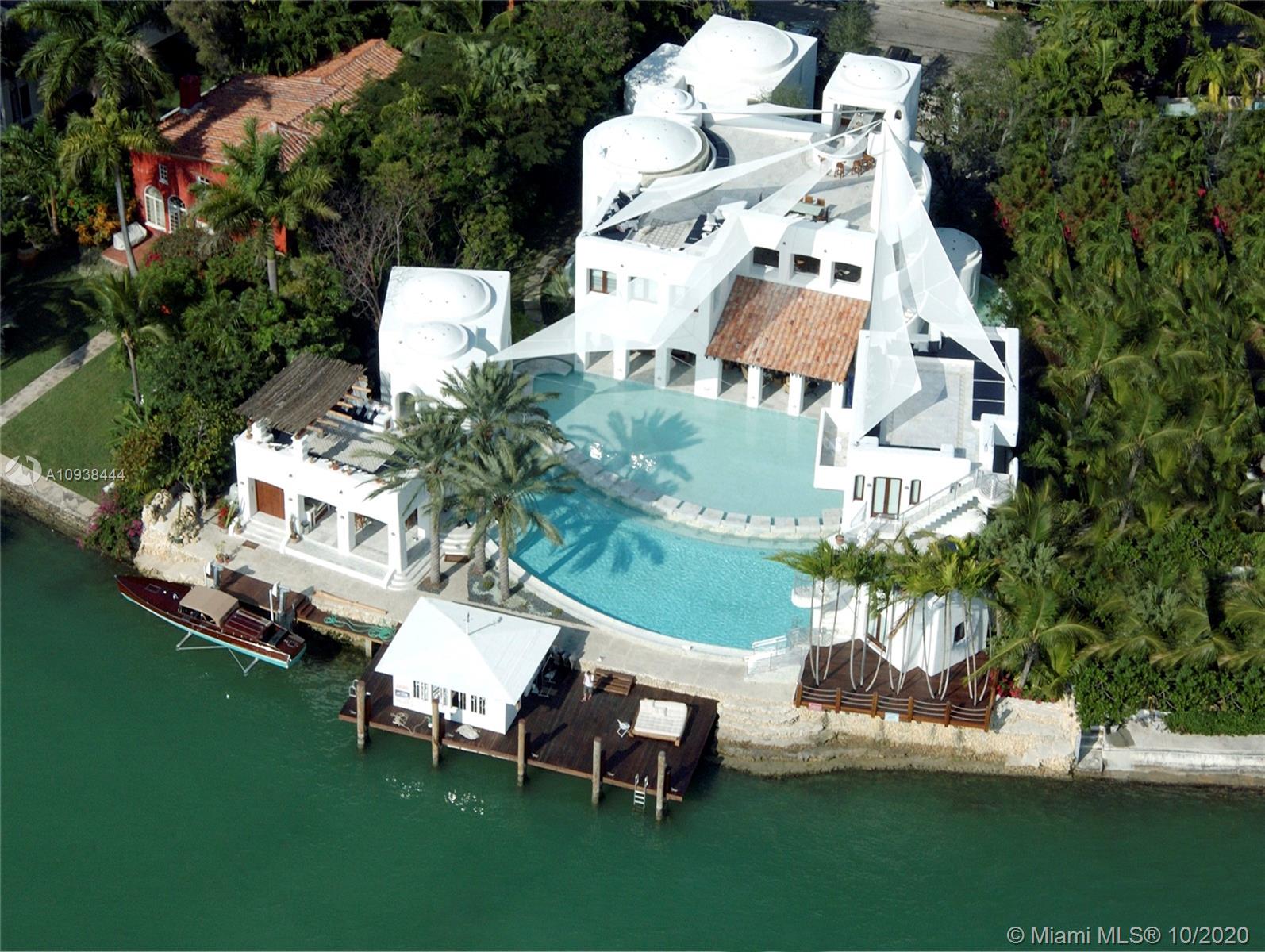 Rare opportunity to own a Unique Mykonos meets Miami Masterpiece located in Miami Beach’s gated Hibiscus Island. This one-of-a kind irreplaceable island estate features over 13,000+ SF of outdoor/indoor living area ,150 FT of water frontage with 6 bedrooms, 6.1 bathrooms, a pool house, boat house, and breathtaking downtown skyline and open bay views. The open living spaces, high ceilings, and rooftop terraces on both the main house and guest house make it the perfect home for entertaining. This home has been featured in multiple architectural & design magazines for its extraordinary style as well as, movies & music videos.