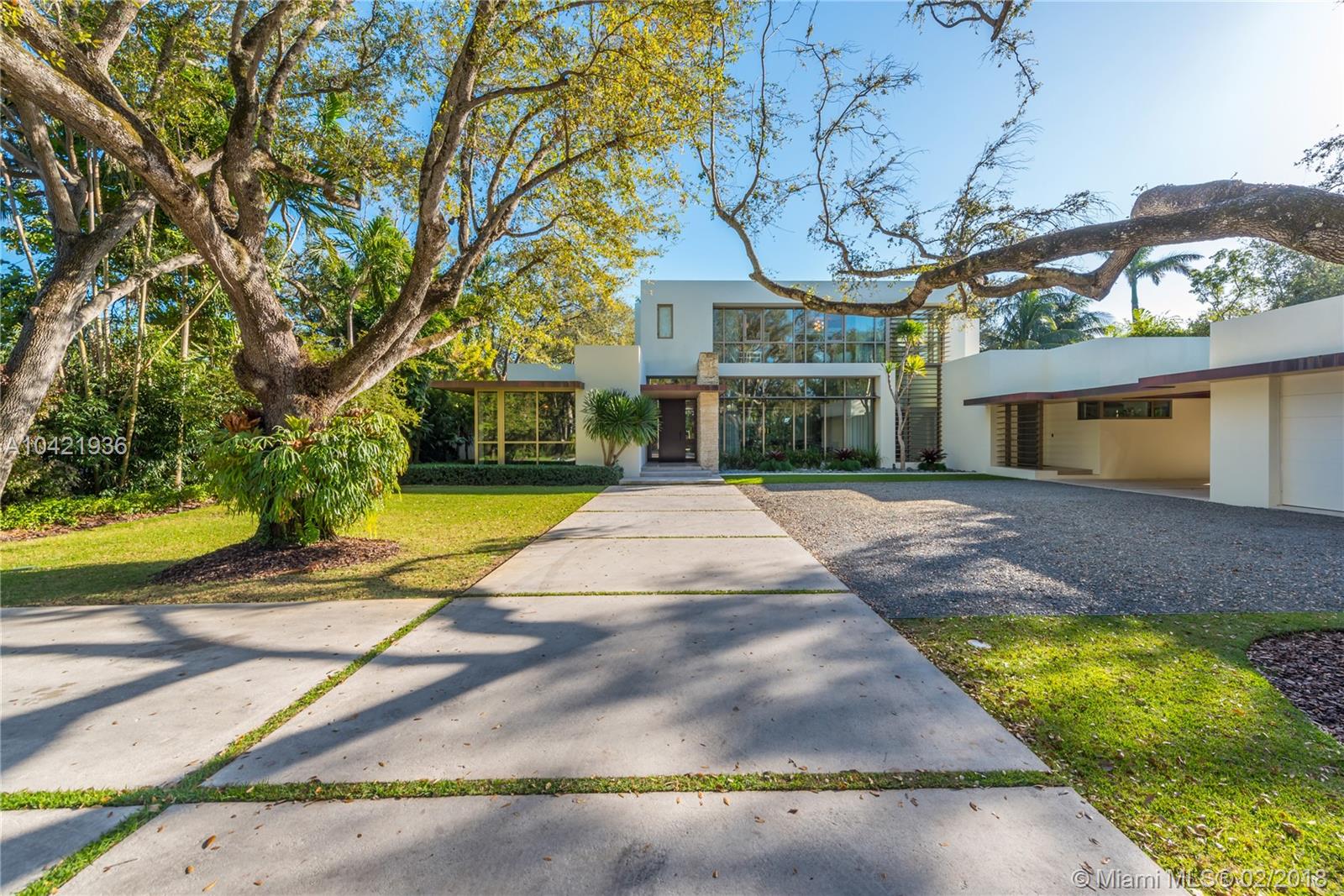 Reminiscent of the work of Richard Neutra, this Mid-Century Modern estate is located in coveted Hammock Lakes. Tucked away and extremely private and secure, the home is poised upon an acre of land, nestled behind Mature Oak Trees and a private Gated Entry. Recently built, the two-story, 7-bedroom home features gleaming marble and wood floors.  Elegantly and stylishly appointed by a top-flight designer, this estate property is perfect for the buyer who wants to move in tomorrow. Features include a Ground Floor Master; large living room with fireplace; dining room with wet bar; gourmet kitchen; spacious pool and deck; lush landscaped grounds; Crestron controlled Smart House; an abundance of natural light throughout the day both indoors and outdoors. NO expense spared in this Custom Home.
