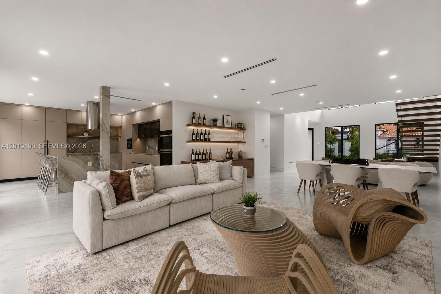 A bold expression of modern architecture in the heart of Little Havana, this newly constructed residence delivers a distinctly urban, loft-inspired lifestyle just minutes from Brickell, Downtown Miami, and LoanDepot Park. Dramatic 19-foot ceilings, a sculptural floating staircase, and gallery-like open interiors create an atmosphere that feels both sophisticated and effortlessly cool. The designer kitchen features striking surfaces, custom cabinetry, and elevated finishes curated for contemporary living. Upstairs, the primary suite offers a private retreat, while secondary bedrooms share a sleek Jack-and-Jill layout. Every bedroom opens to its own balcony and includes custom-built closets. Outside, a lounge-style patio was designed for entertaining under the Miami skyline. Rarely does a home with this level of architectural presence and modern edge become available in one of Miami’s most culturally iconic neighborhoods.