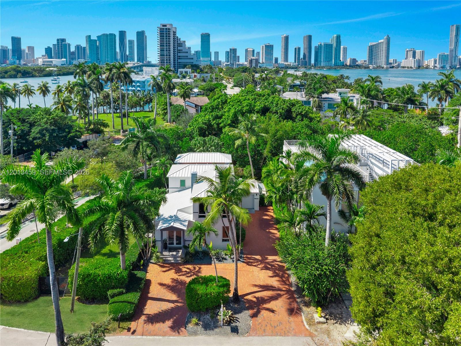 A CAPTIVATING BLEND OF MED-DECO CHARM & CONTEMPORARY COMFORT IN THE HEART OF THE VENETIAN ISLANDS! 4 bedrooms + 3.5 bathrooms spanning 2,912 SF on a 7,500 SF lot surrounded by Lush Tropical Gardens. The main living area with a Fireplace & White Vaulted ceilings opens to a Bright Family Room overlooking a private covered Patio with a Bar. The Backyard features a Heated Pool framed by Green Gardens with Banyan Trees & Royal Palms + Summer kitchen & Dining Area. Open kitchen with Gray Granite countertops, Stainless Steel appliances + built-in Wine cooler. Spacious Primary Suite with a walk-in closet & an Oversized Bathroom with Soaking Tub, shower & double vanity. Office with Light oak flooring & built-in shelving. 1-car garage + Driveway that can fit 4 cars. Moments away from Miami Design District & Sunset Harbour. Located in one of Miami’s most desirable neighborhoods, the home offers easy access to fine dining, luxury shopping, marinas, and cultural destinations.