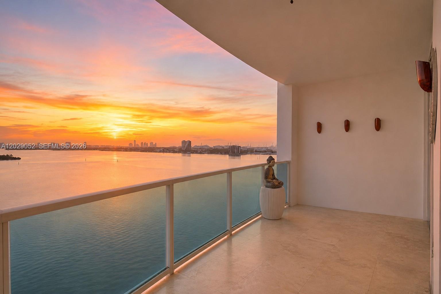 Completely renovated 1-bedroom, 1-bath residence at New Wave — the only unit in the building featuring a true full gut renovation. Open-concept layout with seamless flow between the living, dining, and kitchen areas. Elegant black marble floors throughout.

Custom European-style kitchen with floor-to-ceiling cabinetry, smoked glass upper cabinets, integrated appliances, and LED lighting. Designer wallpaper accent walls add texture and sophistication throughout the residence. Custom glass doors allow natural light to flow while maintaining privacy, enhancing the open and airy feel of the space.

Built-out walk-in closet featuring LED strip lighting, custom shelving, shoe displays, and integrated drawer systems. Recessed lighting throughout. Zero original finishes remain. Every detail was intentionally curated — this is far beyond a cosmetic renovation.

New Wave offers 24-hour concierge, waterfront pool, fitness center, valet parking, and secured entry. Waterfront building designed by renowned architect Kobi Karp in the heart of Edgewater — walkable to Margaret Pace Park and minutes from Wynwood, Design District, Brickell, and Miami Beach.

One covered parking space included. Move-in ready. Truly turnkey. Master bedroom chandelier not included in the sale.