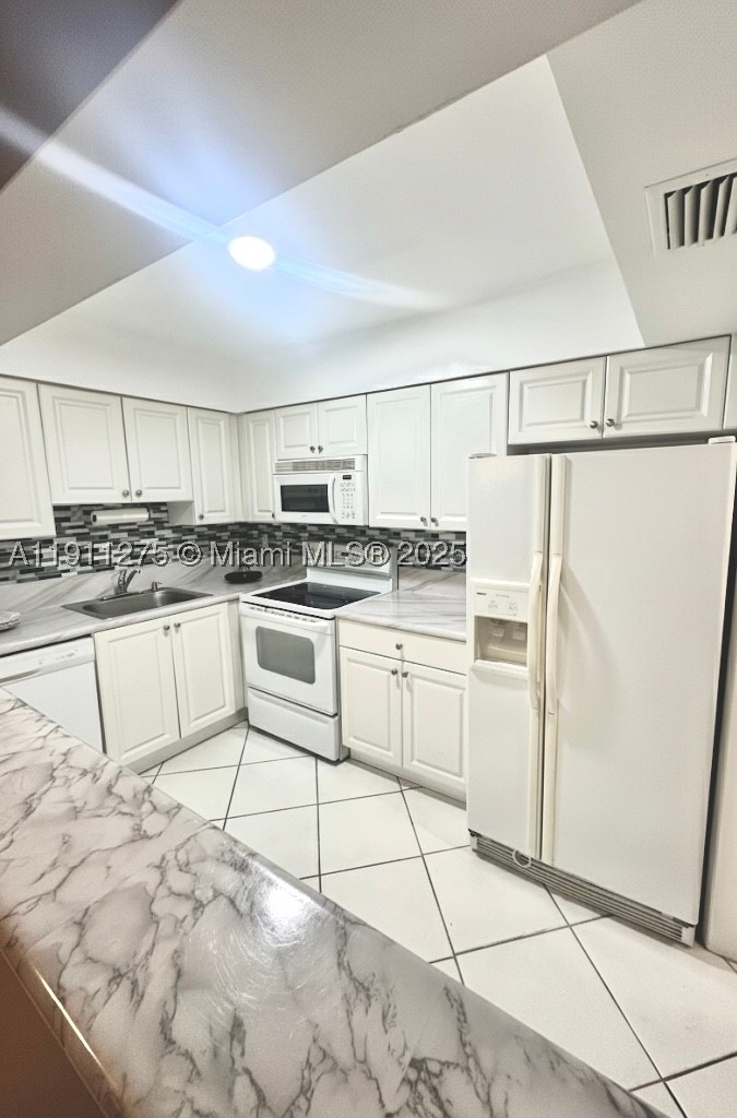 Beautifully updated 1BR/1.5BA condo in the desirable Inverrary community! This bright and spacious unit features modern finishes, updated kitchen and refreshed bathrooms. Enjoy serene golf course and garden views from your private screened balcony. Secure building with resort-style amenities including pool, clubhouse, fitness area, and walking paths. Conveniently located near shopping, dining, and major highways. Perfect for year-round living or a South Florida getaway! Seller is willing to pay the cost of 3 months Condo fees as a buyer's contribution.