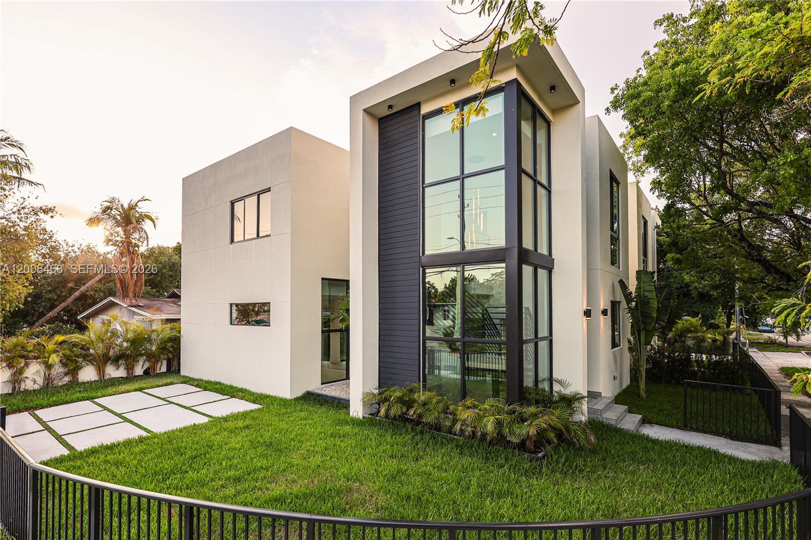 Experience modern Miami living in this exceptional architectural single family home, completed in 2026. Featuring 4 bedrooms and 4 bathrooms, the open concept living spaces flow seamlessly into lush landscaping, creating a true indoor-outdoor lifestyle. A dramatic 25-foot double height storefront glass facade welcomes you into a striking foyer with an oak staircase, while the interior showcases a modern kitchen with Calacatta countertops, floating vanities, and contemporary finishes throughout. The second-floor laundry adds convenience, and the gated property offers enclosed parking, screened by a tall green hedge for privacy. Centrally located, it provides easy access to the Miami Design District, Edgewater, Wynwood’s vibrant art scene, Miami International Airport, and premier shopping, dining, and cultural destinations. No Flood​​‌​​​​‌​‌​​​‌‌​​​‌‌‌​​‌​​‌‌​​​​ Zone.