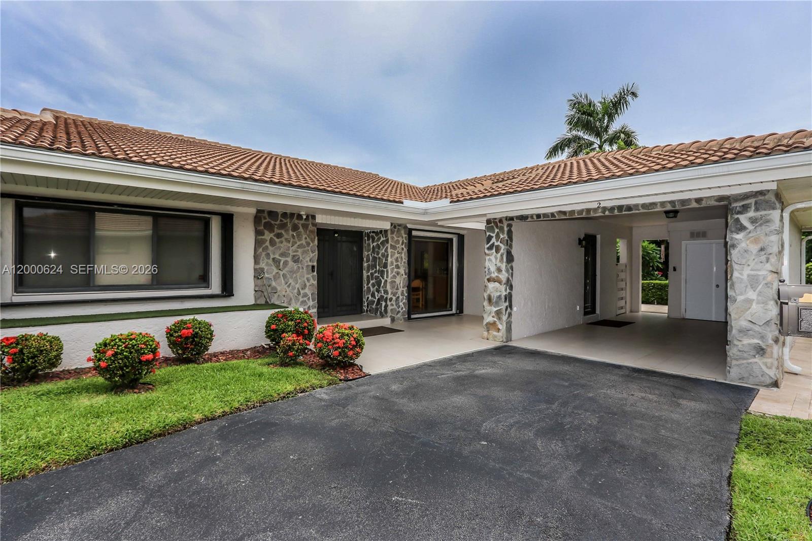 Beautifully updated 3 bed, 3 bath corner unit in a gated, private community with peaceful golf course views and no rear neighbors. This bright and spacious home features vaulted ceilings, crown molding, recessed lighting, and custom interior doors. Enjoy a custom kitchen with quartz countertops, stainless steel appliances, farmer’s sink, and ample cabinetry. Two primary suites offer flexibility and comfort. Impact windows and doors, plus hurricane shutters, provide peace of mind. Extras include a 1-car carport, wired surround sound and alarm system, tankless water heater (2024), 5-ton A/C (approx. 8 yrs), and newer tile roof (approx. 2 yrs). Laundry room with butler’s pantry adds function. Relax on your tumbled marble patio or at the community pool. A rare find!