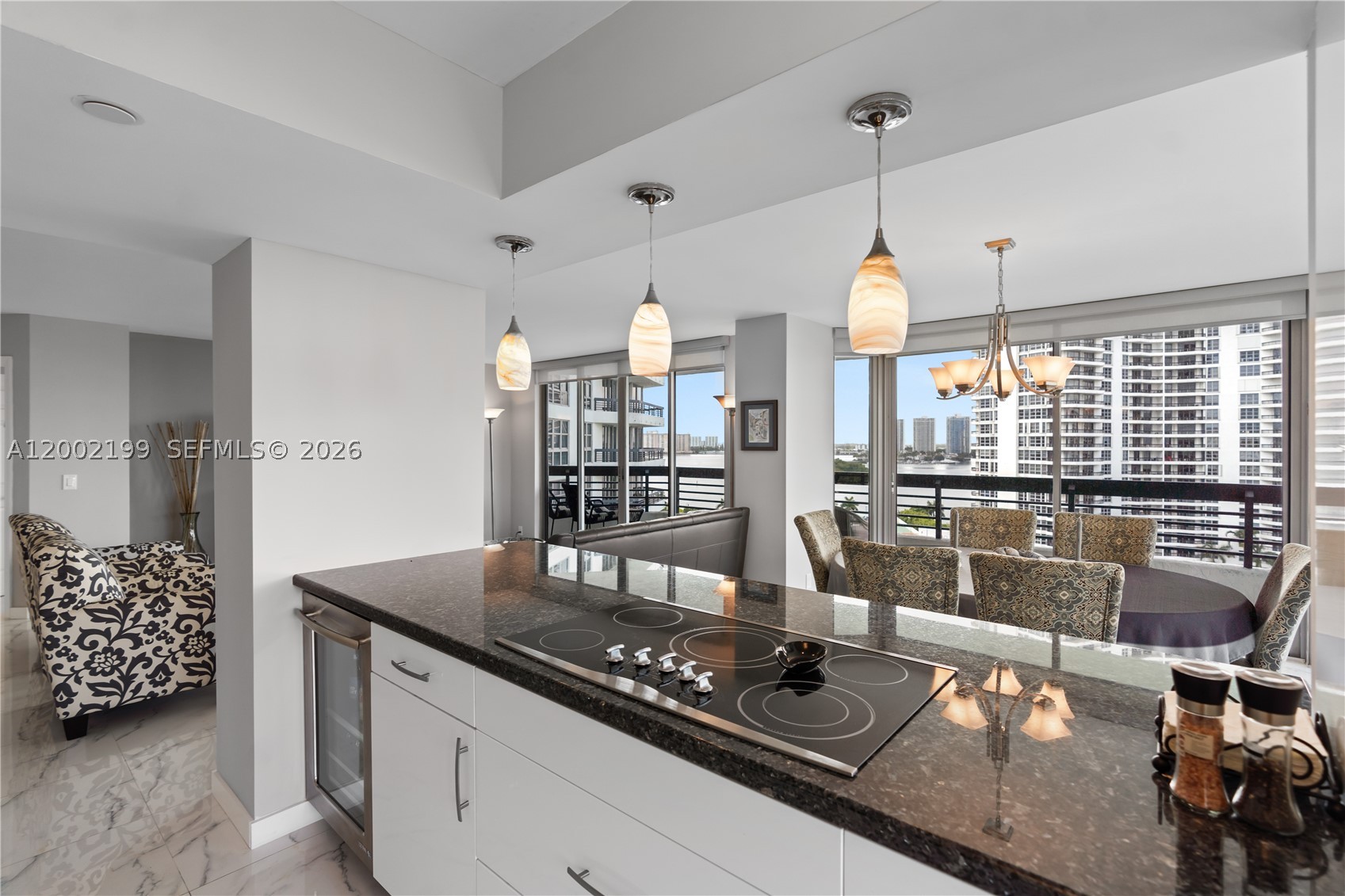 Experience luxury waterfront living in this corner unit condo with Intracoastal views, ideally located in the heart of Aventura just minutes from Aventura Mall, Sunny Isles Beach, and top dining destinations. This bright and spacious residence features a wraparound balcony and abundant natural light, offering the perfect combination of lifestyle, location, and value. Beautifully updated, this Aventura waterfront condo for sale showcases porcelain tile flooring throughout, an open-concept kitchen and premium brand stainless steel appliances, beverage cooler, and an expansive granite countertop that offers ample space and a seamless transition into the dining area—ideal for both everyday living and entertaining. Smooth ceilings, updated lighting, and expansive windows enhance the airy feel of the home, while electric shades provide comfort and privacy. The primary suite serves as a private retreat with dual vanities, a soaking tub, and a fully remodeled shower. The spacious second bedroom features a wall-to-wall closet and marina views. Residents enjoy a full suite of resort-style amenities, including a state-of-the-art fitness center, pool, tennis and pickleball courts, lush gardens, on-site restaurant and café, optional marina, fenced dog park, and electric vehicle stations. Ideally located near beaches, shopping, houses of worship, and top schools. This move-in ready condo with Intracoastal views offers exceptional value. Seller already paid the special assessment in full.