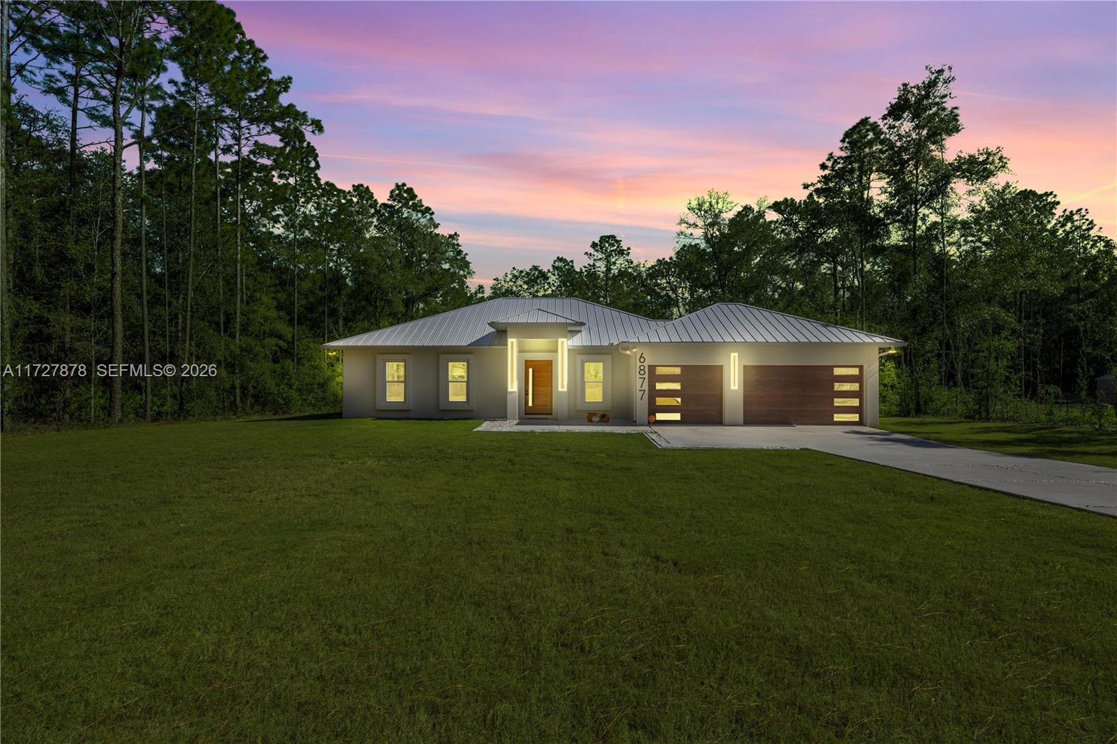 DEVELOPERS NEW SPECIAL PRICE -ICF -INSULATED CONCRETE FORMS- HOME that delivers unmatched storm protection, thermal insulation, superior energy savings, acoustic insulation and a quiet, healthy indoor environment with impressive strength and reliability.Located Rolling Hills, Ocala, FL within 15 minutes from the WEC, near the main National Parks/Springs of Central FL, in a 1.54 acres lot. Built with 150 ft set back from the main road, this 2,284 sq ft i+ 820 sq ft of insulated 3 cars garage this house has Standing Seam Metal Roof,4 beds/3 baths, an open concept kitchen/dining-room/living-room/entertainment area, laundry/mud/utility room. High ceiling of 11' and 4'x4' polished Sahara Spanish tile throughout with all interior doors of 8' of solid wood and low energy windows, custom designed kitchen w/granite island and countertops, stainless steel farmhouse apron front kitchen sink, GE series appliances, double oven, french door refrigerator, wine cooler, induction cooktop, downdraft ventilation system, Samsung Washer/Dryer. Interior Lighting: recessed lighting LED on dimmers throughout. Exterior Lighting: pencil LED lights + LED ceiling light and Spotlights/Sensors. Solid Mahogany front door. Irrigation in 4 Zones. Seamless Gutters with full Leaf Guards throughout; includes underground drainage system. Electrical exterior connection for generator (Stub Out) in place.