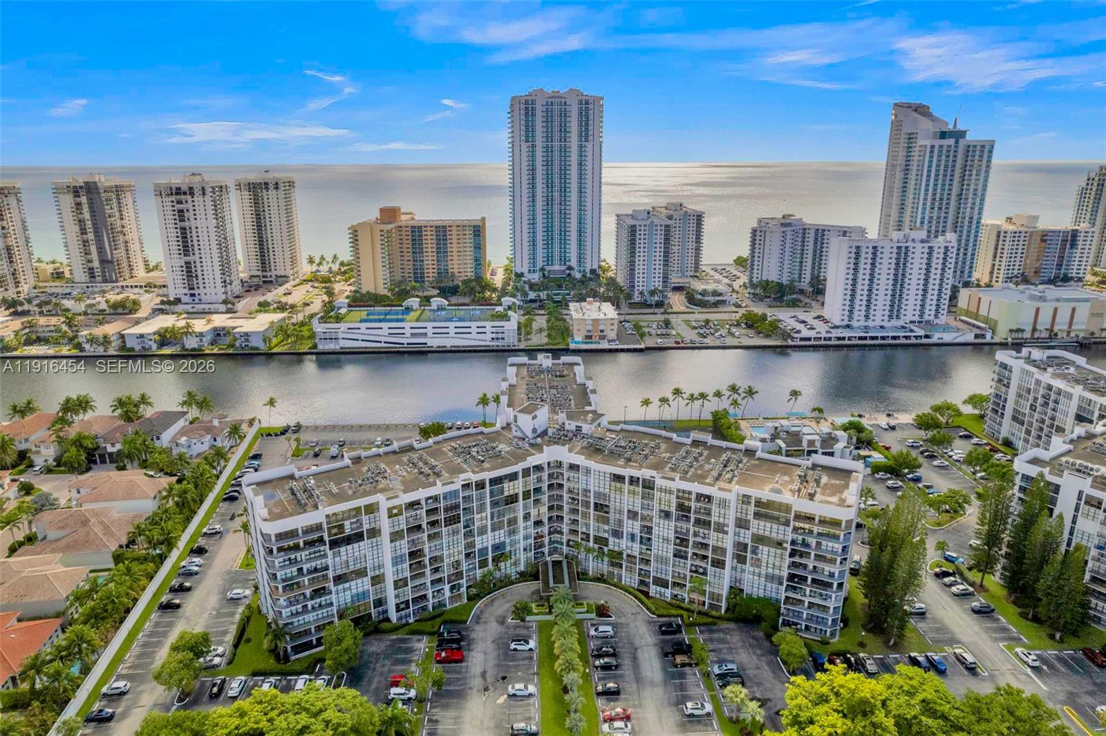 COME TO SEE IT NOW!   Relaxing water views from every room await at this upgraded and extra clean 1 Bed/2 Bath Condo. Spacious rooms with abundant natural light, floor-to-ceiling windows and extra closet space.   The OPEN KITCHEN features updated cabinetry and counter dining. Use the LARGE DEN as your dining room, living room extension or Home Office space.   Available FURNISHED OR UNFURNISHED.   Top waterfront location within the walking-friendly, GATED COMMUNITY of Three Islands with parks, playgrounds and world-class Beaches, Dining, Shopping, Golf & Int. Airports in close proximity.   RESORT-STYLE AMENITIES include waterfront Pool Deck, BBQ Area, Fitness Facilities, Tennis Courts and Club House.  24HR SECURITY/Front Desk. 1 assigned parking space.   CAN BE RENTED right after purchase.