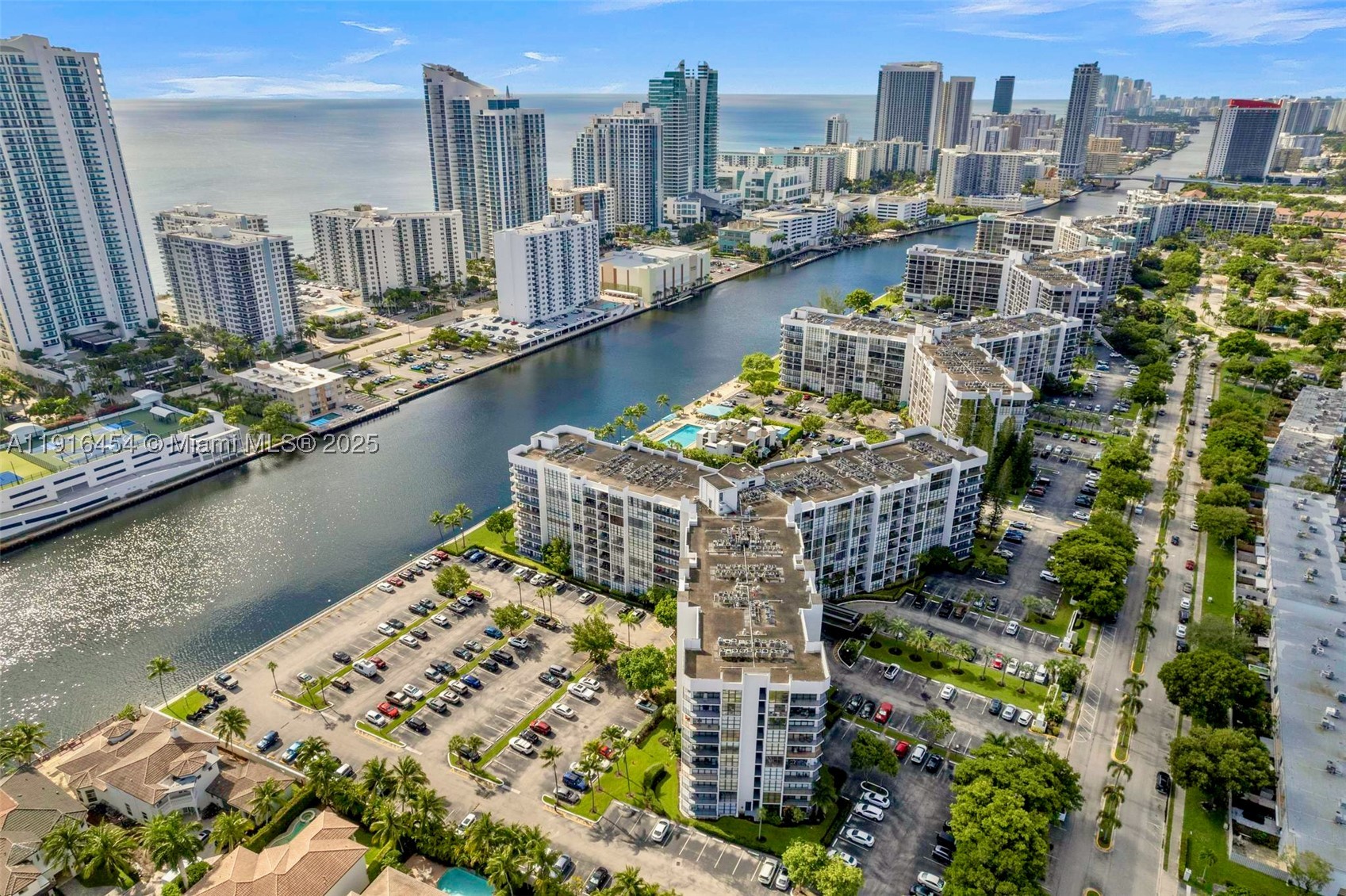 COME TO SEE IT NOW!   Relaxing water views from every room await at this upgraded and extra clean 1 Bed/2 Bath Condo. Spacious rooms with abundant natural light, floor-to-ceiling windows and extra closet space.   The OPEN KITCHEN features updated cabinetry and counter dining. Use the LARGE DEN as your dining room, living room extension or Home Office space.   Available FURNISHED OR UNFURNISHED.   Top waterfront location within the walking-friendly, GATED COMMUNITY of Three Islands with parks, playgrounds and world-class Beaches, Dining, Shopping, Golf & Int. Airports in close proximity.   RESORT-STYLE AMENITIES include waterfront Pool Deck, BBQ Area, Fitness Facilities, Tennis Courts and Club House.  24HR SECURITY/Front Desk. 1 assigned parking space.   CAN BE RENTED right after purchase.