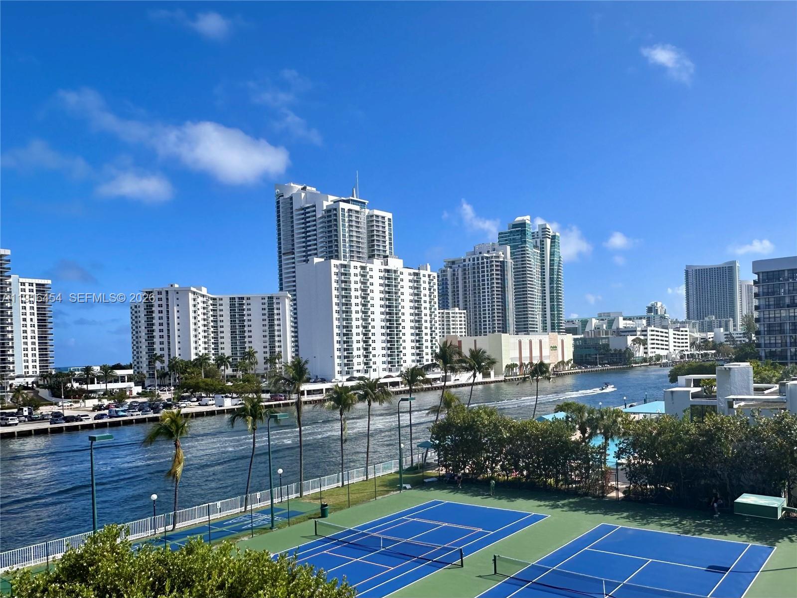 COME TO SEE IT NOW!   Relaxing water views from every room await at this upgraded and extra clean 1 Bed/2 Bath Condo. Spacious rooms with abundant natural light, floor-to-ceiling windows and extra closet space.   The OPEN KITCHEN features updated cabinetry and counter dining. Use the LARGE DEN as your dining room, living room extension or Home Office space.   Available FURNISHED OR UNFURNISHED.   Top waterfront location within the walking-friendly, GATED COMMUNITY of Three Islands with parks, playgrounds and world-class Beaches, Dining, Shopping, Golf & Int. Airports in close proximity.   RESORT-STYLE AMENITIES include waterfront Pool Deck, BBQ Area, Fitness Facilities, Tennis Courts and Club House.  24HR SECURITY/Front Desk. 1 assigned parking space.   CAN BE RENTED right after purchase.