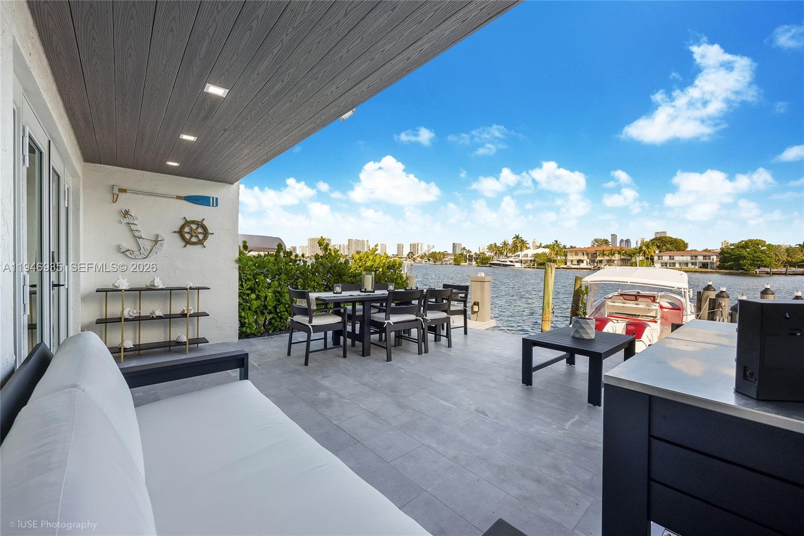 Modern townhome offering breathtaking water views across Maule Lake with a deeded perpendicular dock that fits up to a 40 foot boat with direct ocean access and no fixed bridges. This beach house provides a functional split-level layout ideal for entertaining. This house features sleek 48 by 48 Italian porcelain flooring, black stainless-steel appliances, impact windows & doors, and a laundry area conveniently located on the upper level. The primary suite is complete with a custom walk-in master closet and panoramic water views. Brand new roof was completed June 2025 and all special assessments have already been paid in full.