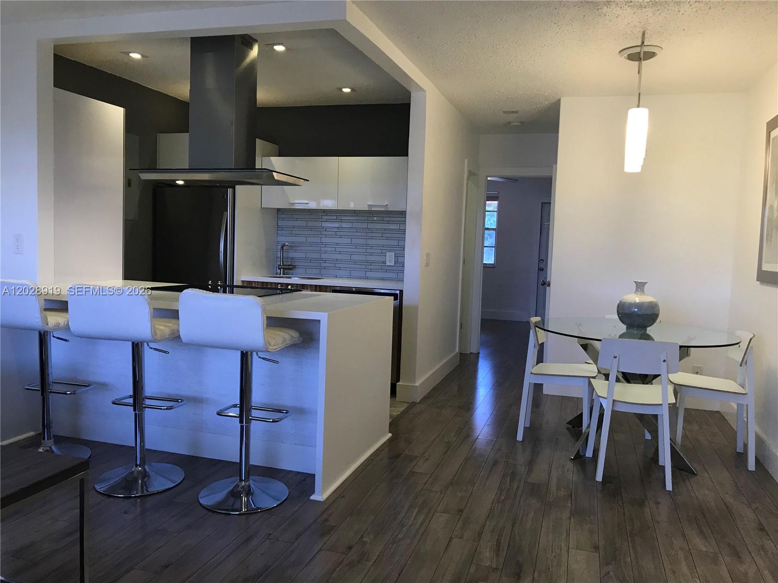 REMODELED CONDO UNIT IN A HIDDEN CORNER OF HOLLYWOOD. HIGH-END FINISHES, STAINLESS STEEL APPLIANCES (FRIDGE, GLASS TOP STOVE, OVEN, HOOD, DISHWASHER) CUSTOM MADE ITALIAN KITCHEN WITH ACRYLIC DOORS AND WHITE CORIAN COUNTERTOP. NEW BATHROOM WITH CUSTOM-MADE GLASS DOOR AND VANITY. RECESS LIGHTS, OAK WOOD LAMINATED FLOORS, HIGH IMPACT FRONT DOOR... AND MORE. FACILITIES INCLUDE A SWIMMING POOL AND COMMUNITY LAUNDRY.